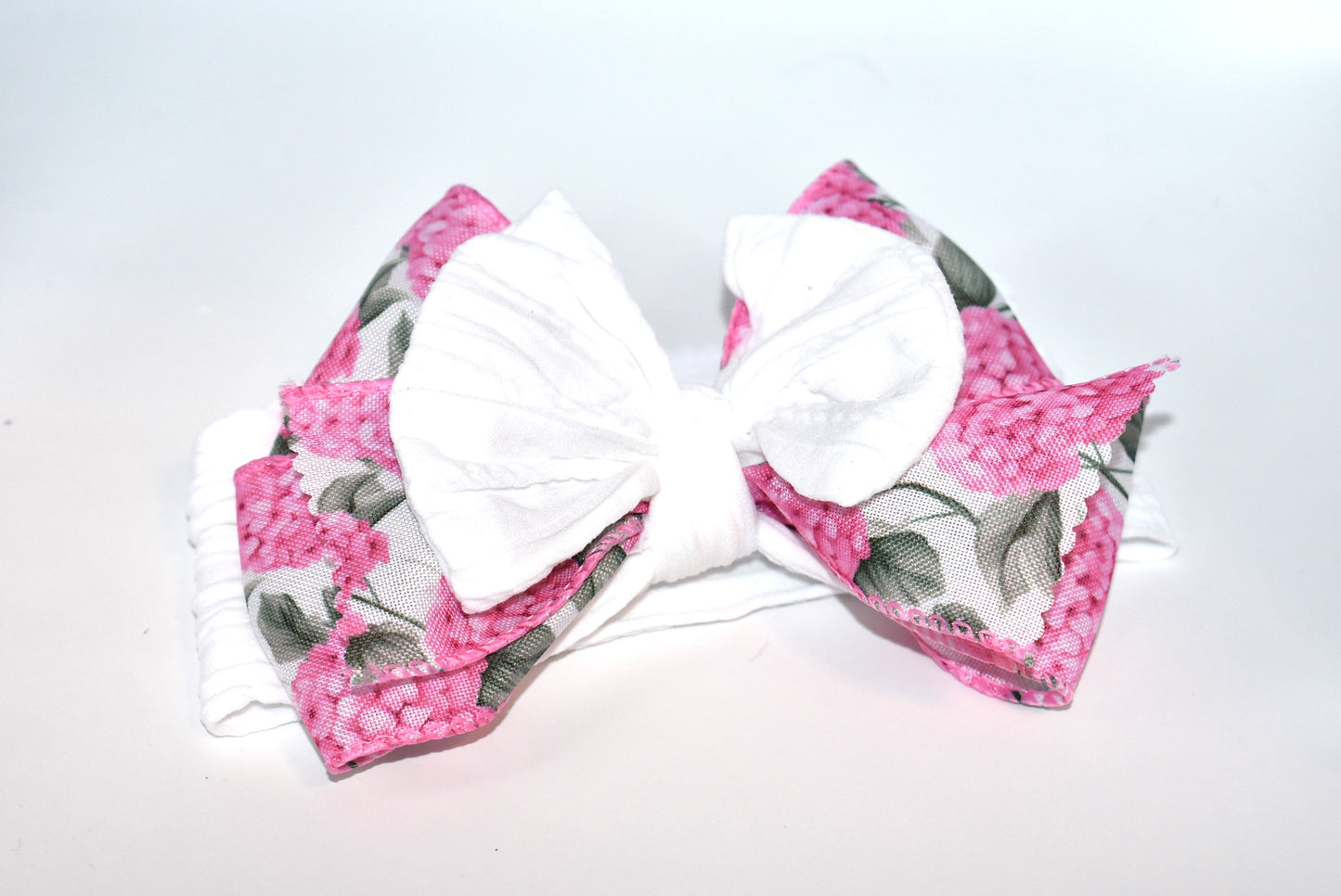 Add a pop of charm with this Wrapped Headband Collection 3! 🌸 Featuring a playful bow on top and a stunning pink flower ribbon beneath, it's the perfect accessory to catch those admiring glances. Comfortable and unique, this wide headband is your go-to for effortless style and a little touch of fun! 🎀✨