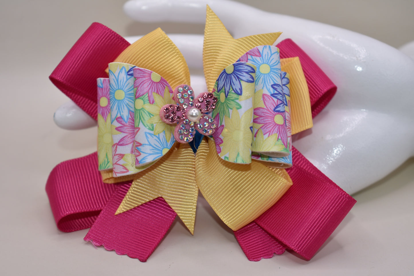 Nana's Collection 83 - Adorable faux leather flowered pattern with a colorful bow and sparkly flower to add the perfect touch to your little cutie's outfit. Includes a wrapped alligator clip for all day secure wear. #FlowerPower 🌸
