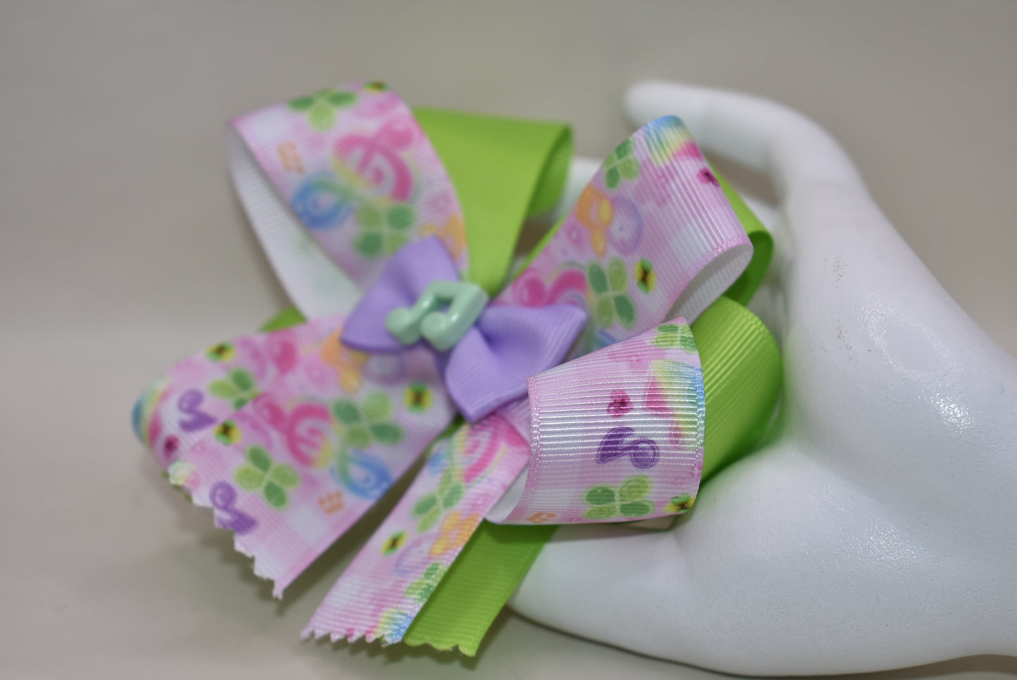 Perfect for your little music enthusiast! 🎵 This adorable bow features musical ribbon topped with a cute note charm, creating a harmonious accessory she'll love! 🎀 Securely attached to a wrapped alligator clip for comfortable all-day wear without slipping. 🎶 Let her show off her musical spirit with this playful addition to Nana's Collection! 💕