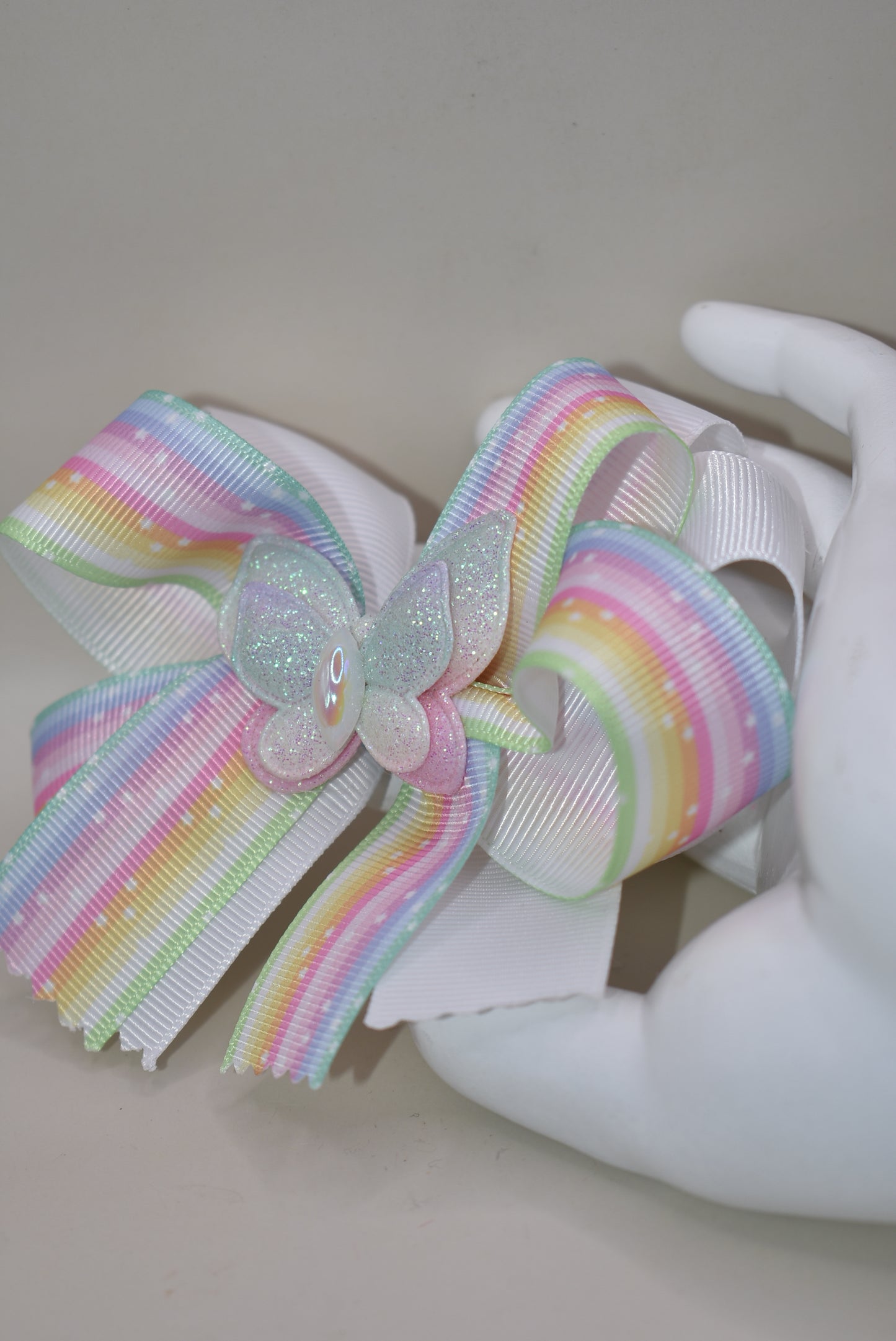 Elevate your little one's style with this enchanting pastel rainbow ribbon bow! 🌈✨ Topped with a sparkly butterfly that catches the light, this adorable hair accessory brings magical charm to any outfit. 🦋 The secure alligator clip ensures it stays put through all her adventures! Perfect for your color-loving princess who wants to stand out with playful flair. 💕 #NanasCollection