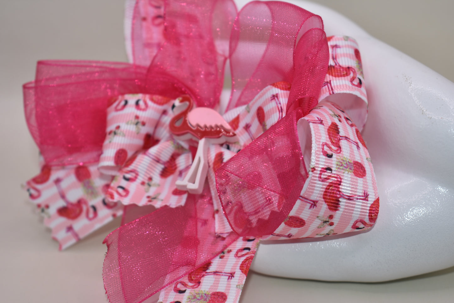 Add a splash of fun with Nana's Collection 104! 🌸 This playful hair clip features a pretty flamingo ribbon in vibrant hot pink, paired with hot pink chiffon that matches perfectly. 🦩 The wrapped alligator clip ensures comfy, easy wear for your little flamingo fans. Perfect for brightening up any day with a touch of tropical charm! 🌺✨