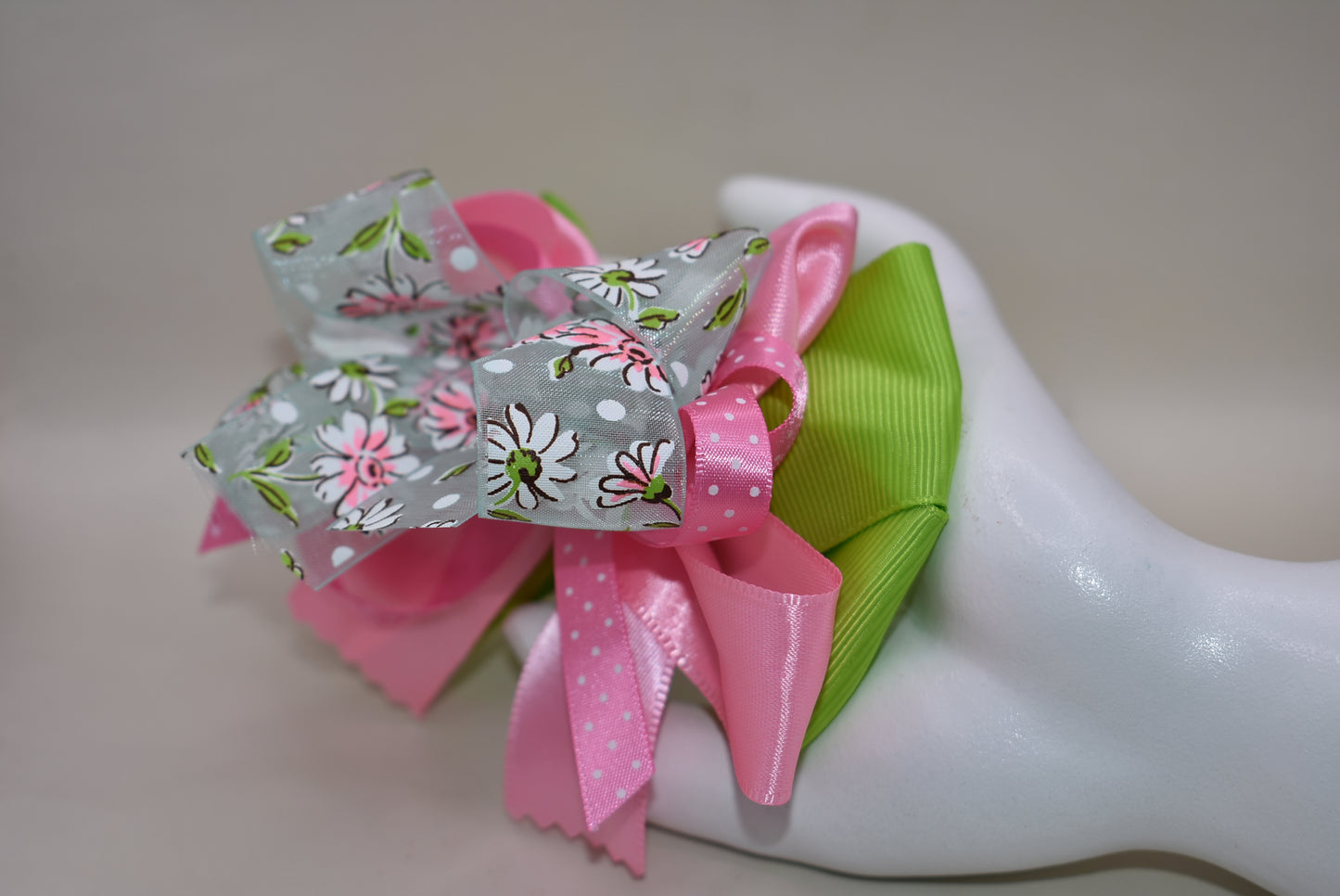 Add a splash of charm with Nana's Collection 106! 🌸 Delightful layers of silk, grosgrain, and organza ribbons in soft pinks and greens create a sweet, playful look. The delicate flower design on the organza ribbon adds an extra touch of whimsy 🌷. Finished with a wrapped alligator clip, it stays put all day for endless fun! 🎀✨