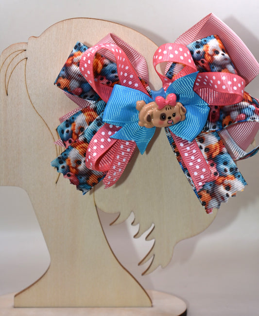 Add a splash of fun with this adorable dog charm from Nana's Collection! Featuring layers of a cute pup and a cheerful polka dot ribbon, it clips on easily with a wrapped alligator clip—perfect for quick, playful style. 🐶🎀 Clip it on and let the smiles begin!