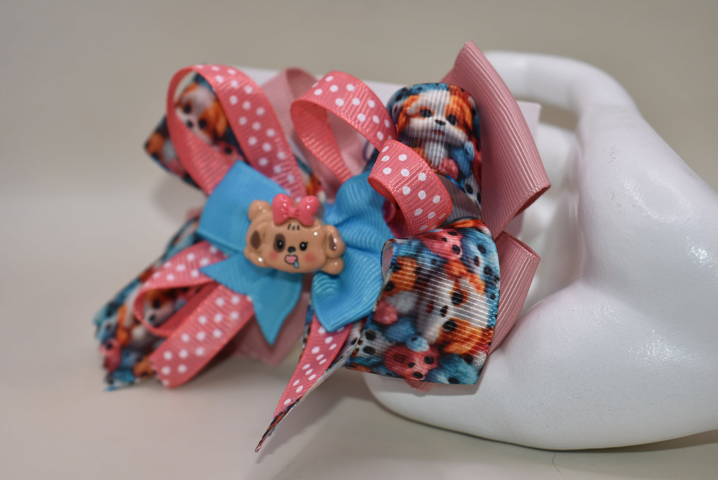 Add a splash of fun with this adorable dog charm from Nana's Collection! Featuring layers of a cute pup and a cheerful polka dot ribbon, it clips on easily with a wrapped alligator clip—perfect for quick, playful style. 🐶🎀 Clip it on and let the smiles begin!