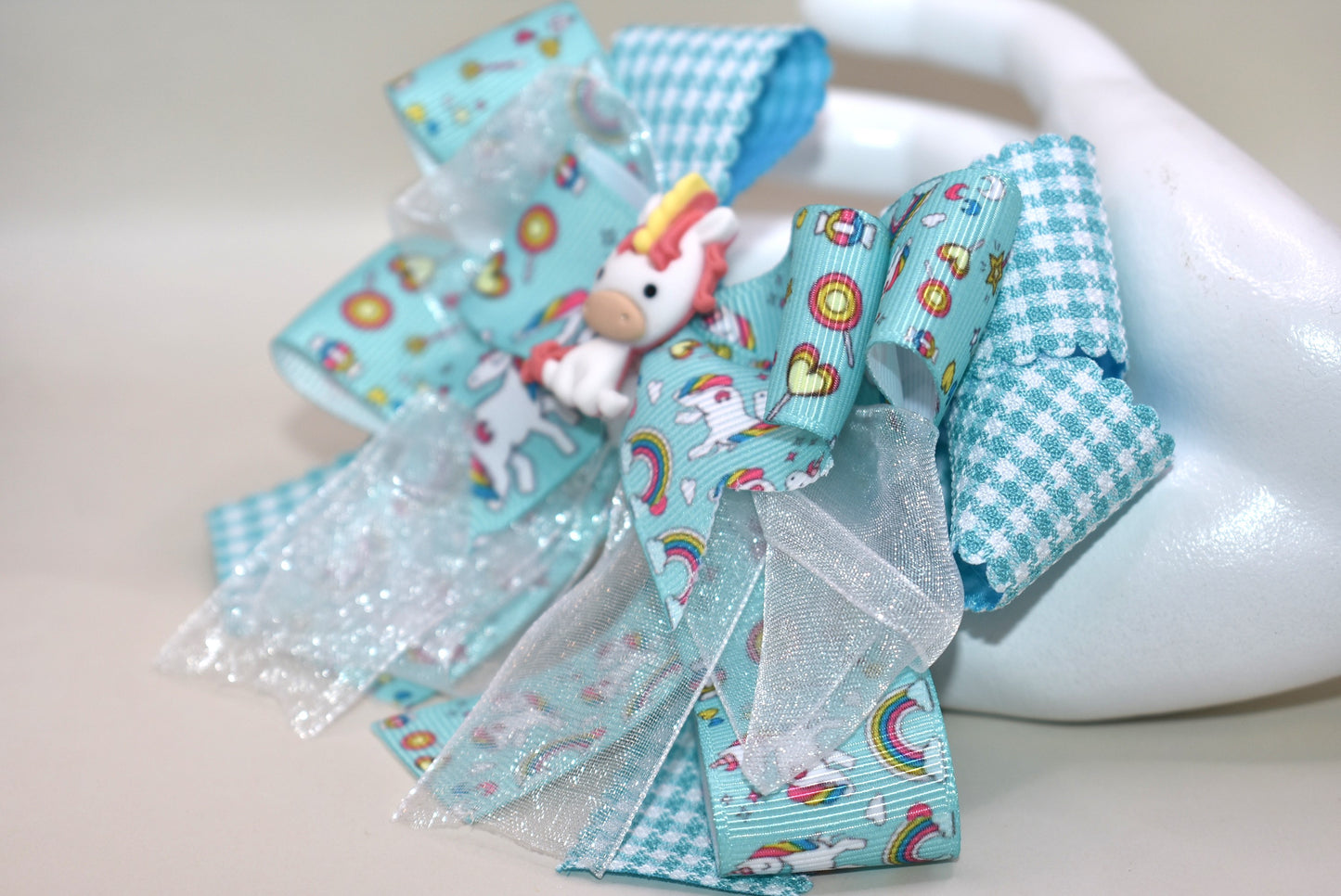 Add a touch of magic with this adorable unicorn motif π¦, featuring layers and layers of pretty ribbon that sparkle in every twirl β¨. Perfect for your little girl, this clip is wrapped with a comfortable alligator clip to keep her hair flawless all day long π. Sheβll fall in love with this charming, playful accessory made just for her! ππ