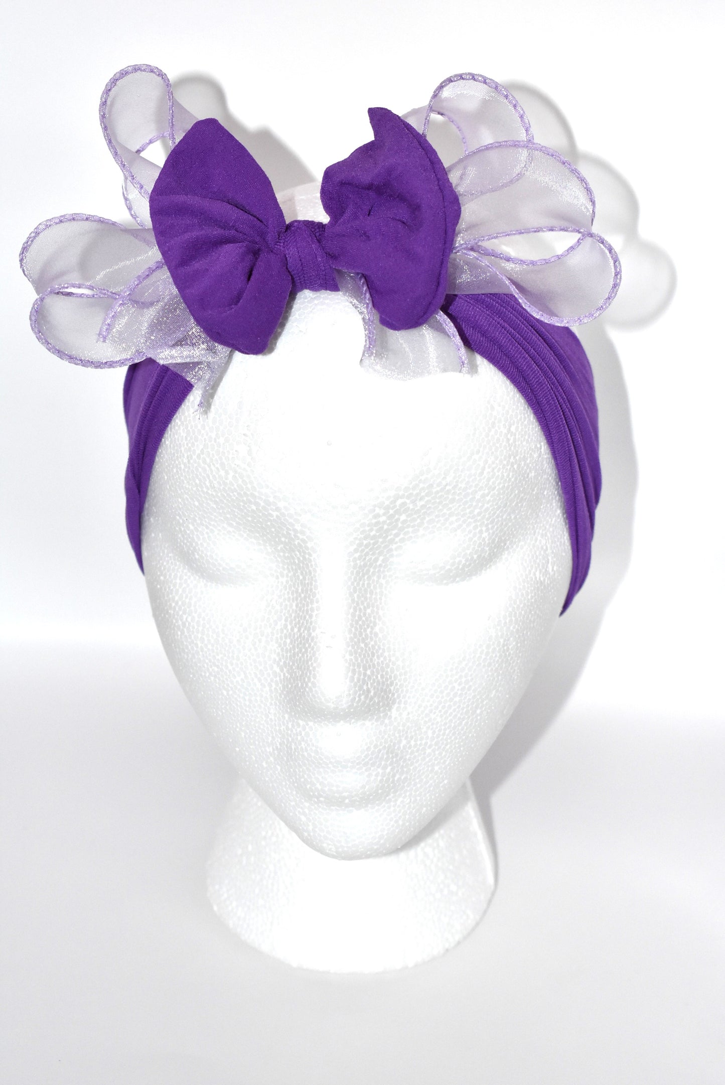 Add a vibrant pop of purple with this wide, soft headband from the Wrapped Headband Collection! 🌸 Featuring a delicate organza bow right in the center, it brings extra charm and love 💜 Perfect for all ages, it's the playful accessory you need to brighten any outfit! ✨