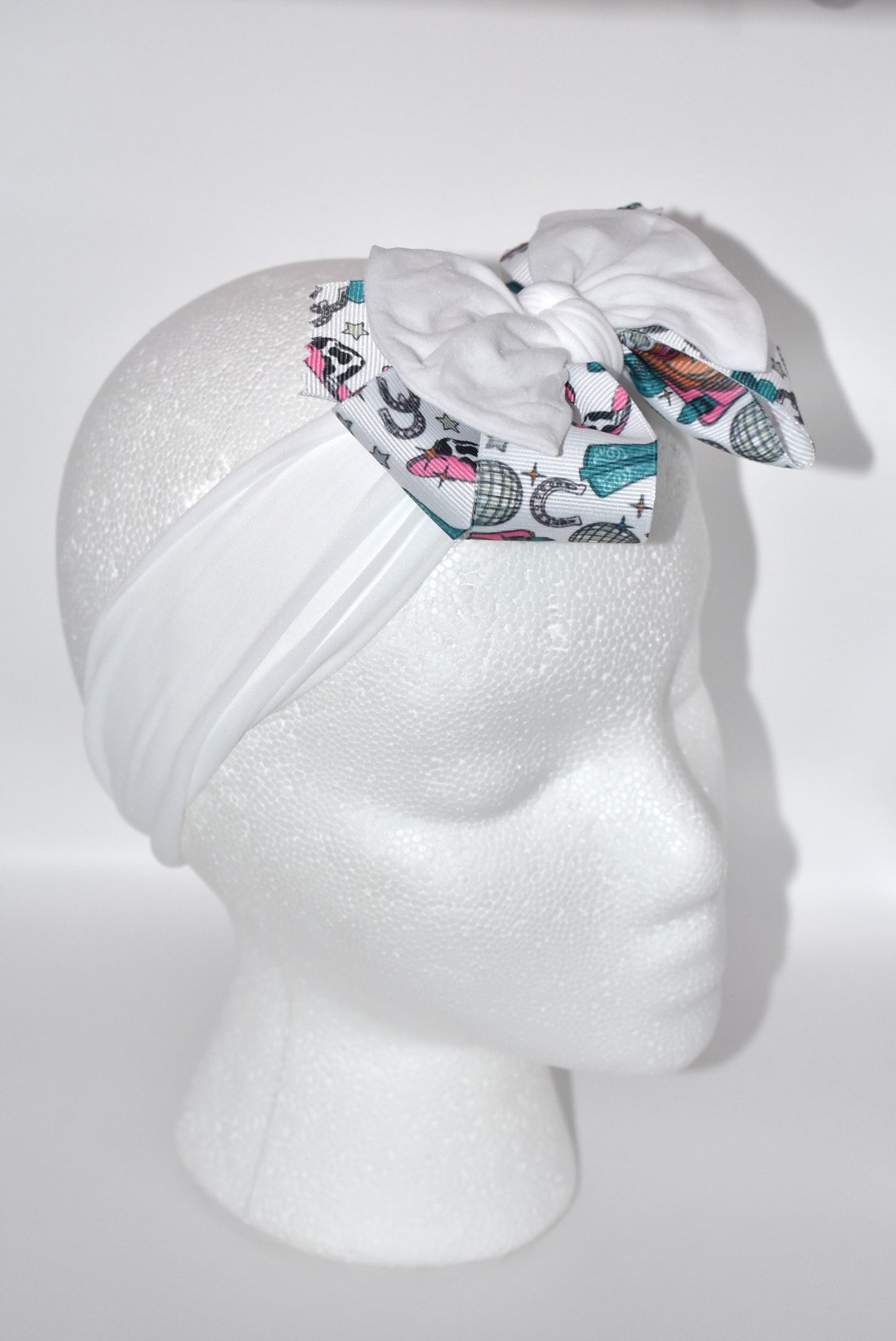 Get ready to ride in style with this pretty white wide headband! Featuring a soft fabric and a charming cowgirl bow in the center, it’s comfortable and perfect for cowgirls of all ages. Add a fun and unique touch to any outfit—giddy up! 🤠🎀💖