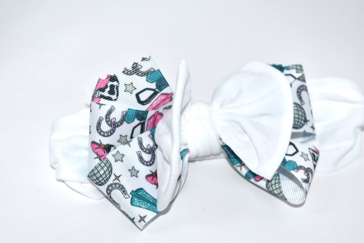Get ready to ride in style with this pretty white wide headband! Featuring a soft fabric and a charming cowgirl bow in the center, it’s comfortable and perfect for cowgirls of all ages. Add a fun and unique touch to any outfit—giddy up! 🤠🎀💖