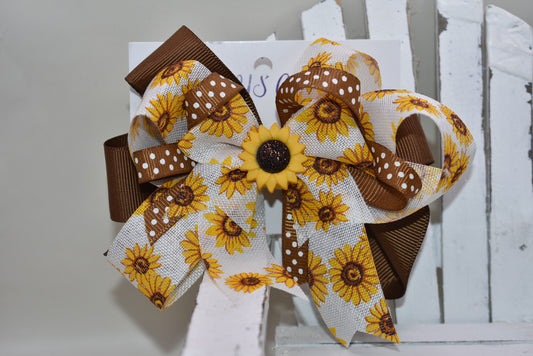 Brighten your little cutie’s day with Nana's Collection 176! This playful sunflower bow features a sunny yellow and brown combo with an adorable sunflower charm on top. The wrapped alligator clip ensures comfy, secure wear all day long. A perfect pop of sunshine for any little outfit! 🌻💛✨