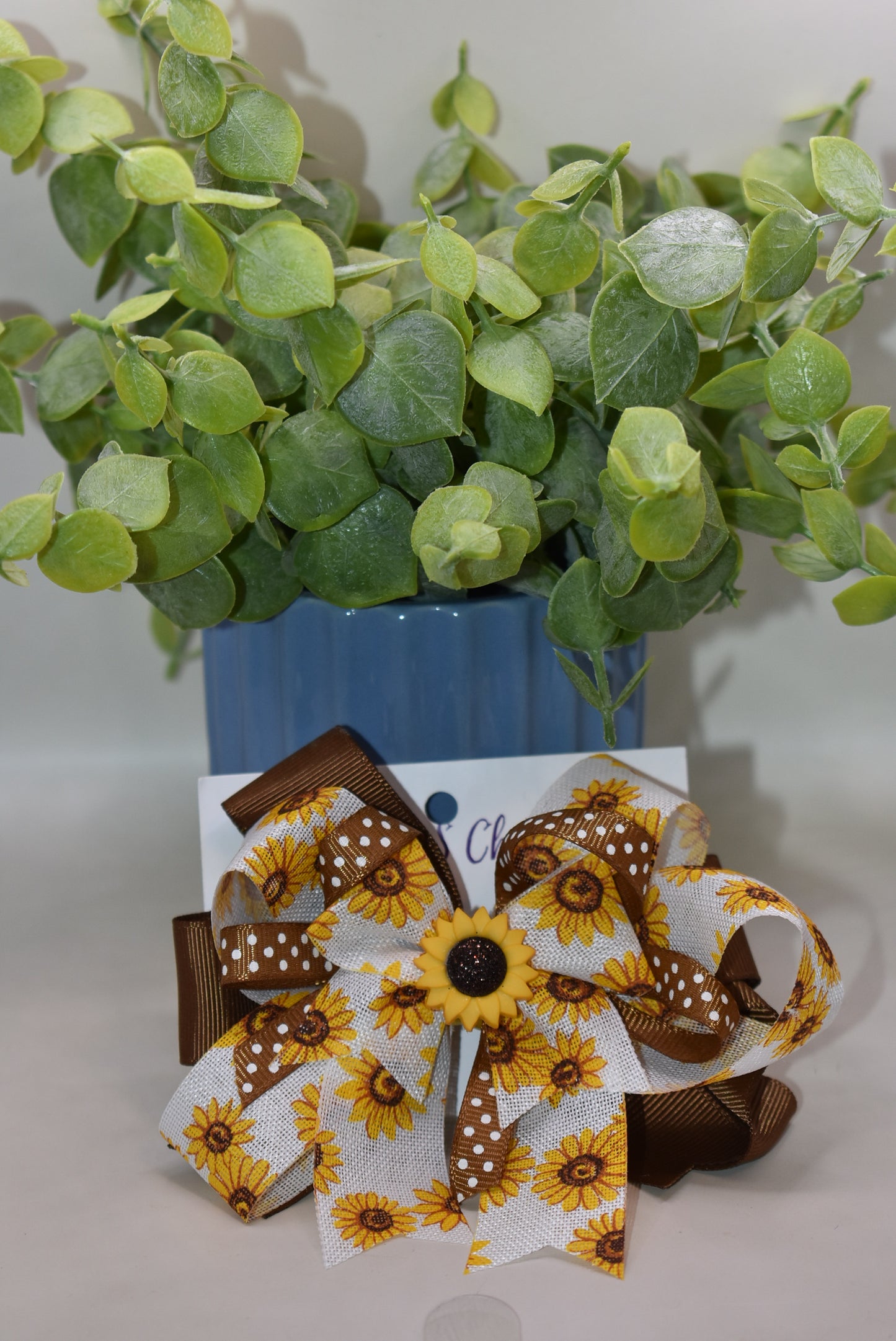 Brighten your little cutie’s day with Nana's Collection 176! This playful sunflower bow features a sunny yellow and brown combo with an adorable sunflower charm on top. The wrapped alligator clip ensures comfy, secure wear all day long. A perfect pop of sunshine for any little outfit! 🌻💛✨