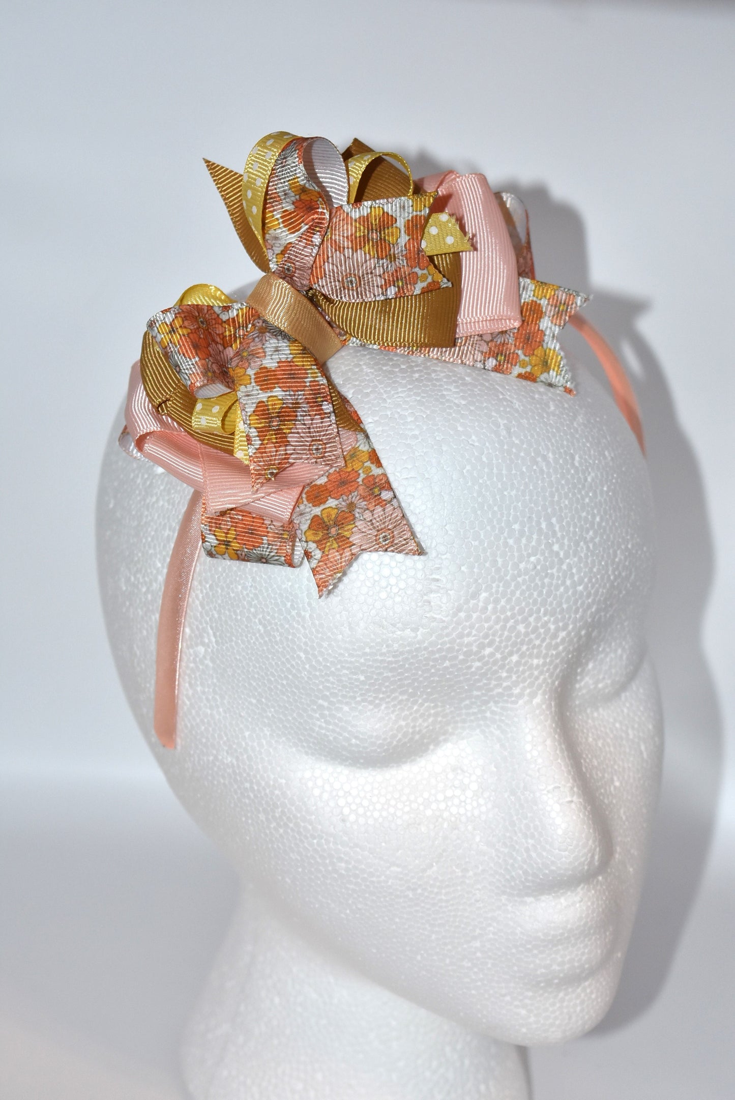 Add a pop of charm with this flower headband 🌸 Layers of delicate ribbons dance atop a slim satin band, bringing playful elegance to any outfit. Perfect all year round, but especially cozy and cute for fall 🍂✨ Embrace your inner flower child with Nana's Headband Collection 7!