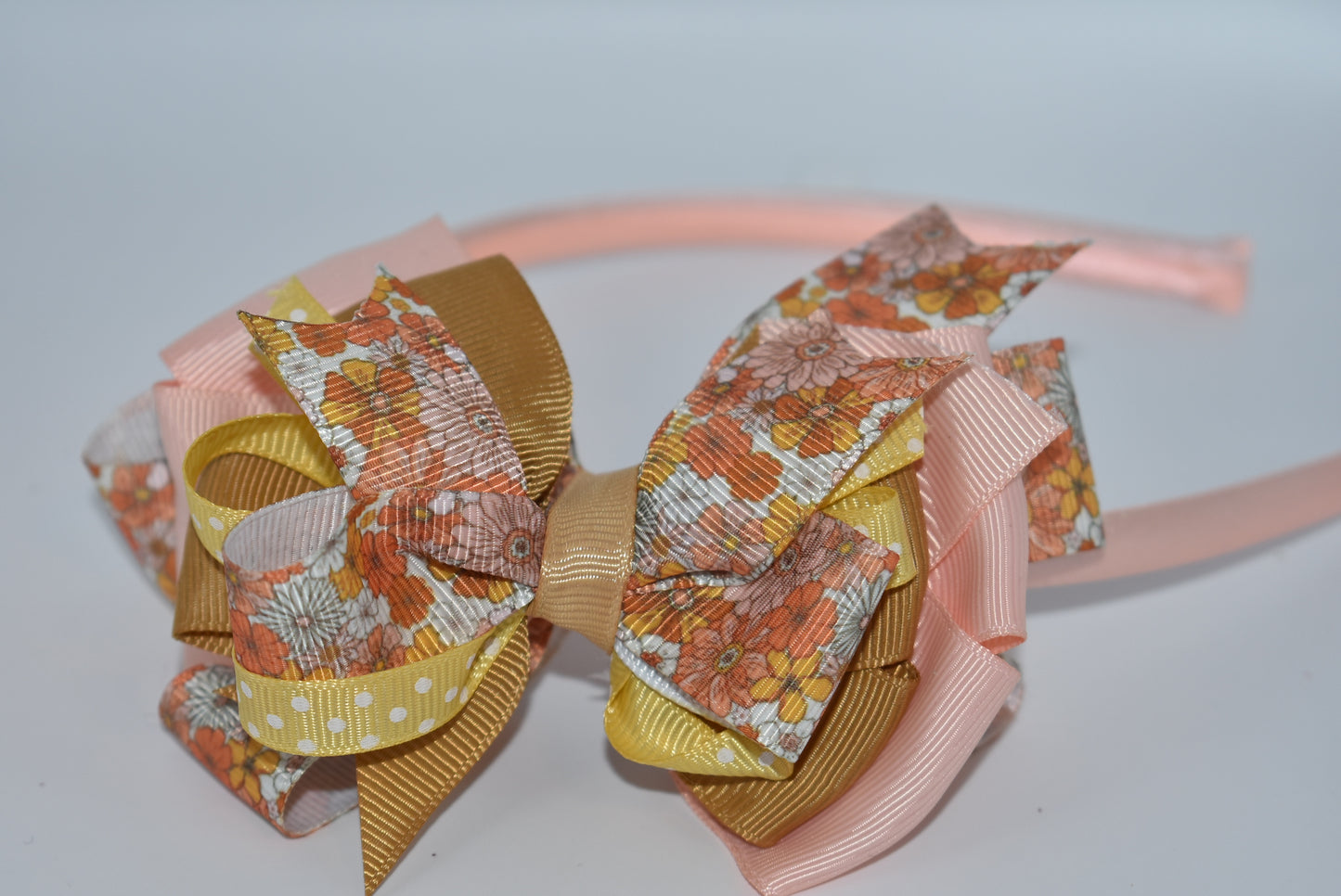 Add a pop of charm with this flower headband 🌸 Layers of delicate ribbons dance atop a slim satin band, bringing playful elegance to any outfit. Perfect all year round, but especially cozy and cute for fall 🍂✨ Embrace your inner flower child with Nana's Headband Collection 7!