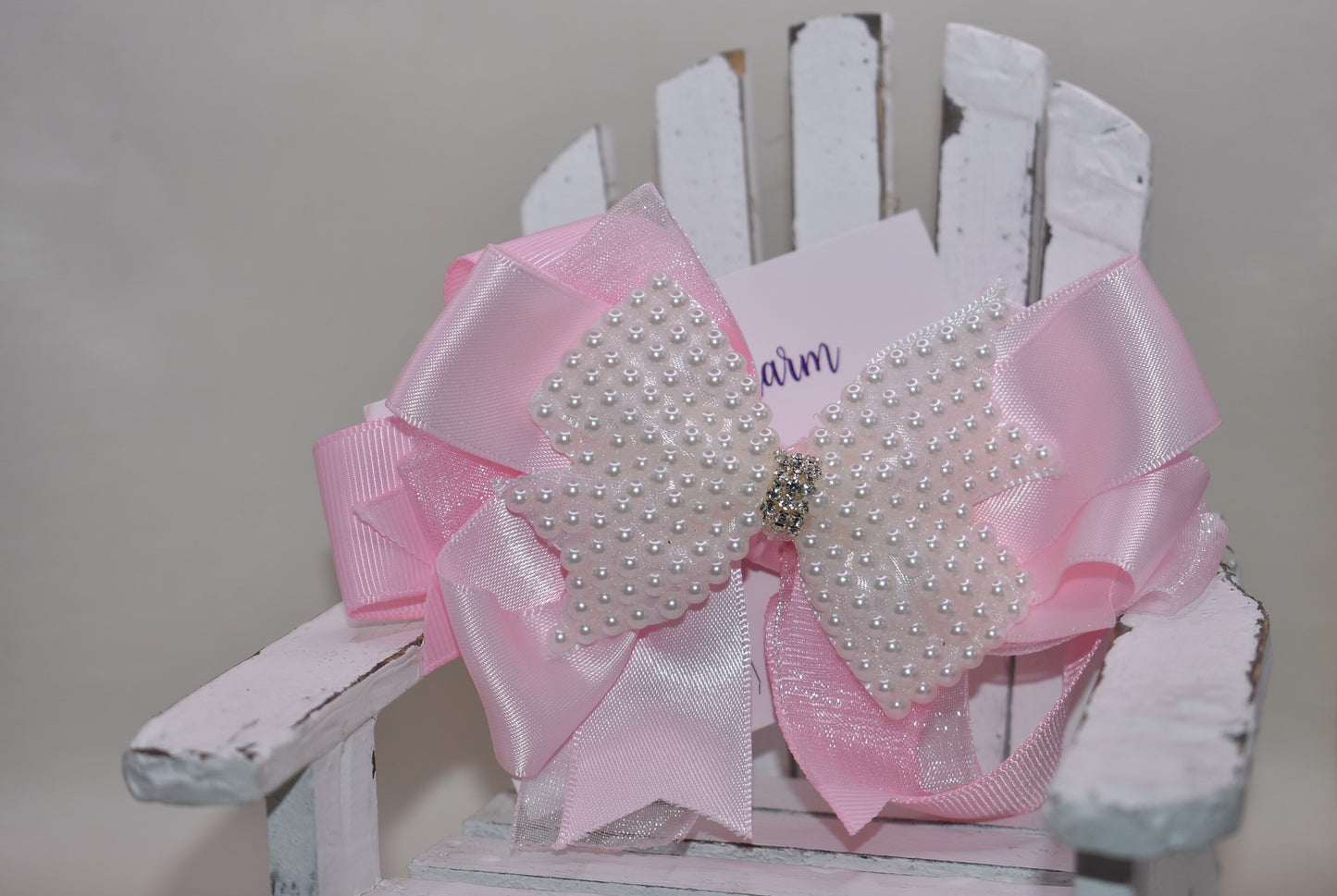 Add a splash of charm with this beautiful pink bow from Nana's Collection! 🌸 Layers of soft pink ribbons create a perfect princess look, topped with a sparkling pearl and crystal wrap ✨. The wrapped alligator clip makes it super easy to wear all day long. Perfect for the little girl who loves everything pink and pretty! 🎀💕