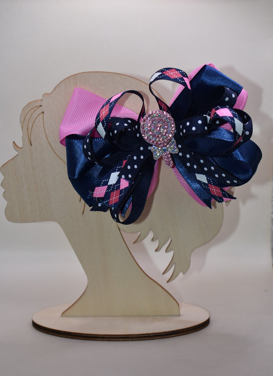 Add a pop of fun with this playful bow from Nana's Collection! Layers of pretty blue and pink ribbons create a charming swirl topped with a sparkling candy embellishment that’s sure to catch the eye 🍬✨. Perfect for adding a little extra sparkle to any outfit, it stays put all day thanks to a handy wrapped alligator clip. Sweet style made easy! 🎀