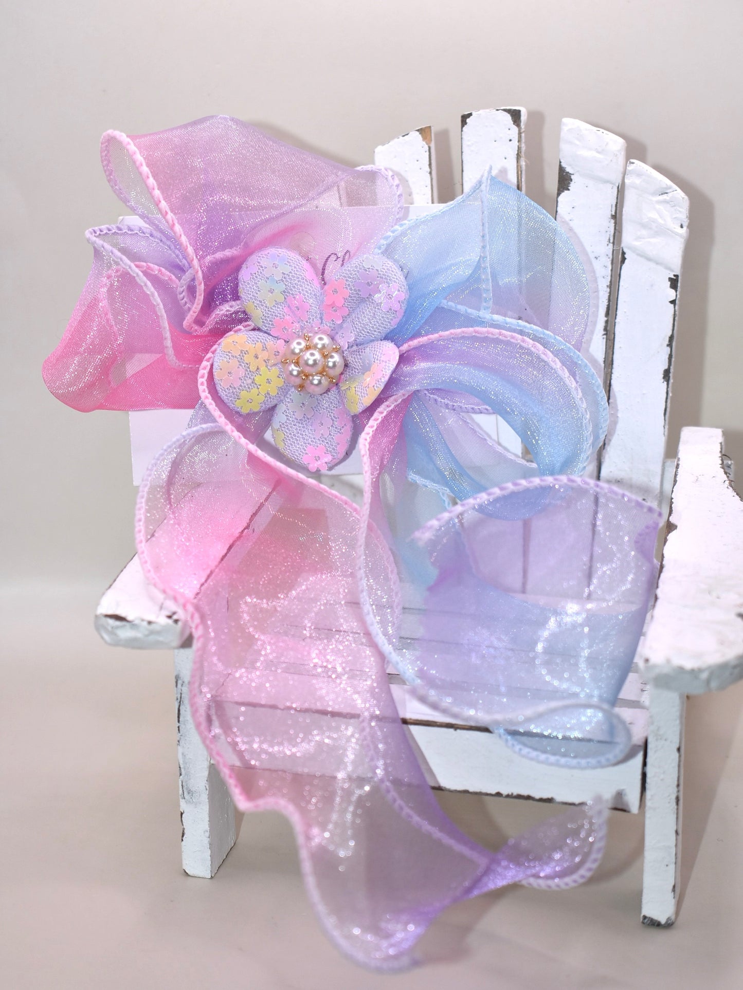 Brighten your style with the Long Tail Collection 2 bow! 🌈 This playful accessory features a colorful sheer ribbon topped with a charming fabric piece and a delicate pearl charm for that perfect touch of sparkle ✨. The wrapped alligator clip on the back ensures a secure fit for all-day wear. Add a pop of fun and elegance to any outfit! 🎀🐚