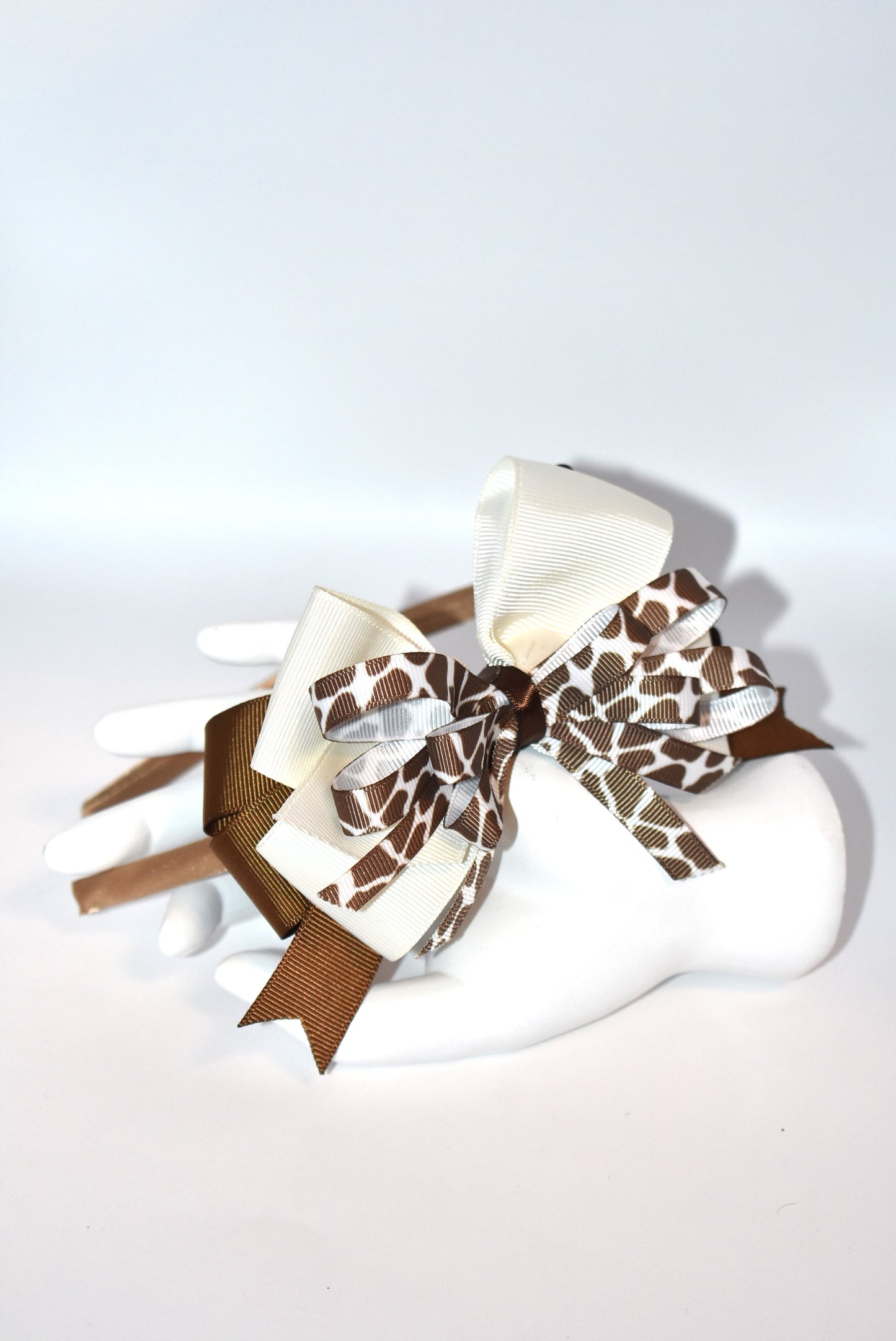 Bring a touch of whimsy to your look with this adorable cow print ribbon headband from Nana's Headband Collection. Featuring a charming brown and cream color combo on a thin satin cocoa brown band, it's as comfy as it is cute—perfect for all-day wear with a playful twist!