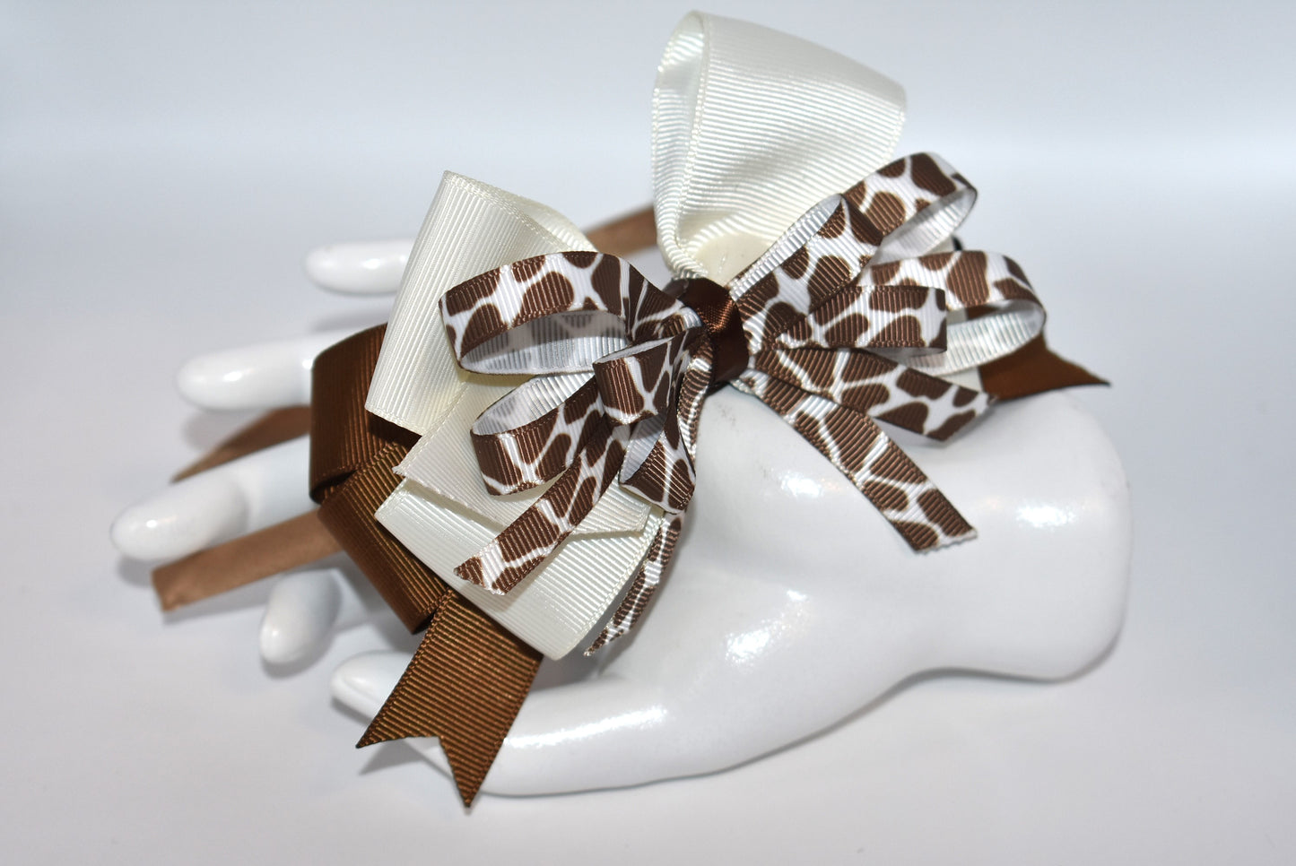 Bring a touch of whimsy to your look with this adorable cow print ribbon headband from Nana's Headband Collection. Featuring a charming brown and cream color combo on a thin satin cocoa brown band, it's as comfy as it is cute—perfect for all-day wear with a playful twist!