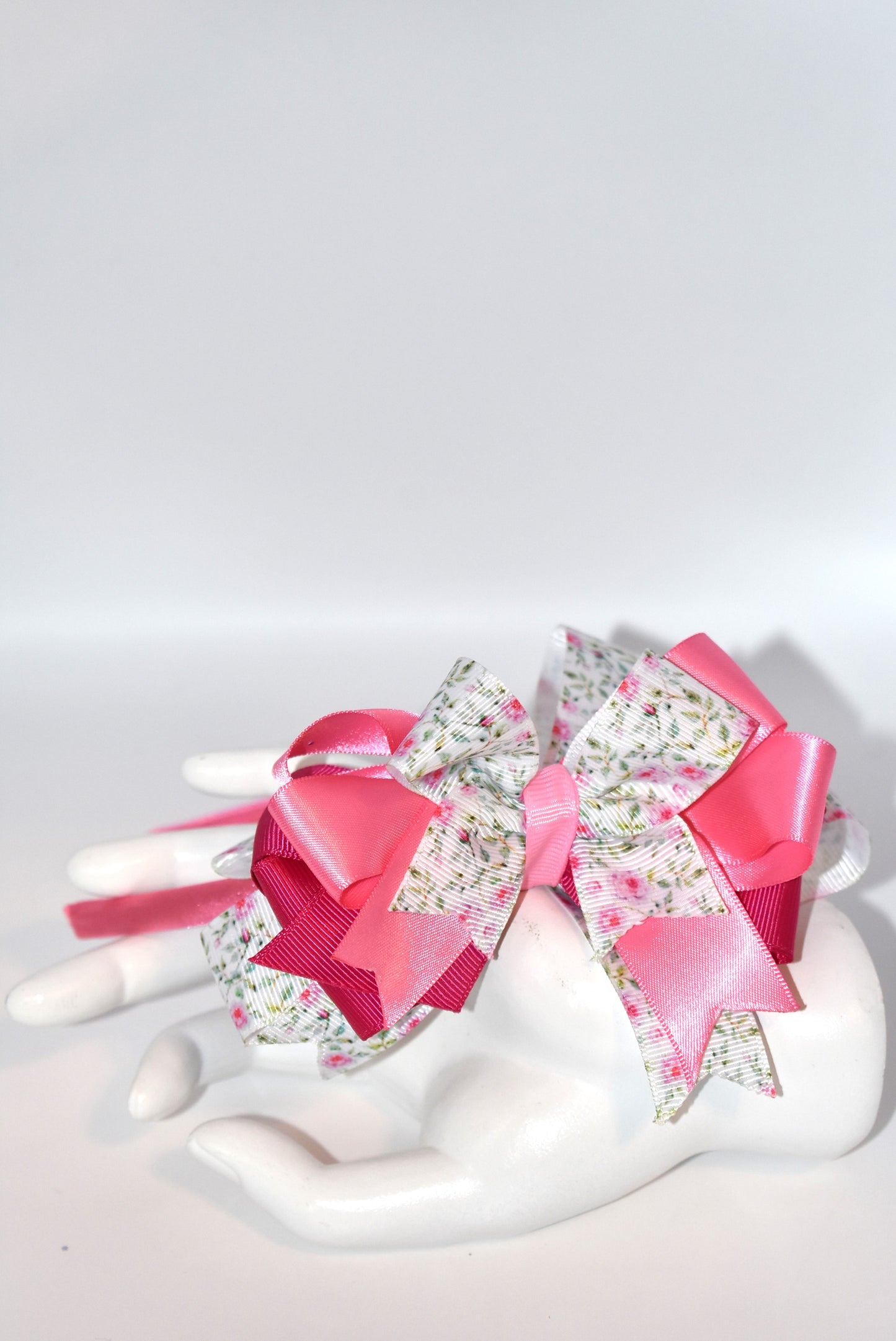 Slip on elegance with this charming pink headband! 💕 Featuring a skinny satin base for comfortable, all-day wear, it's topped with gorgeous layered ribbons that add instant style and sophistication. ✨ Perfect for anyone who loves a touch of feminine flair, this headband combines pretty details with practical design. Whether you're dressing up or keeping it casual, it's your go-to accessory for effortless charm! 🎀