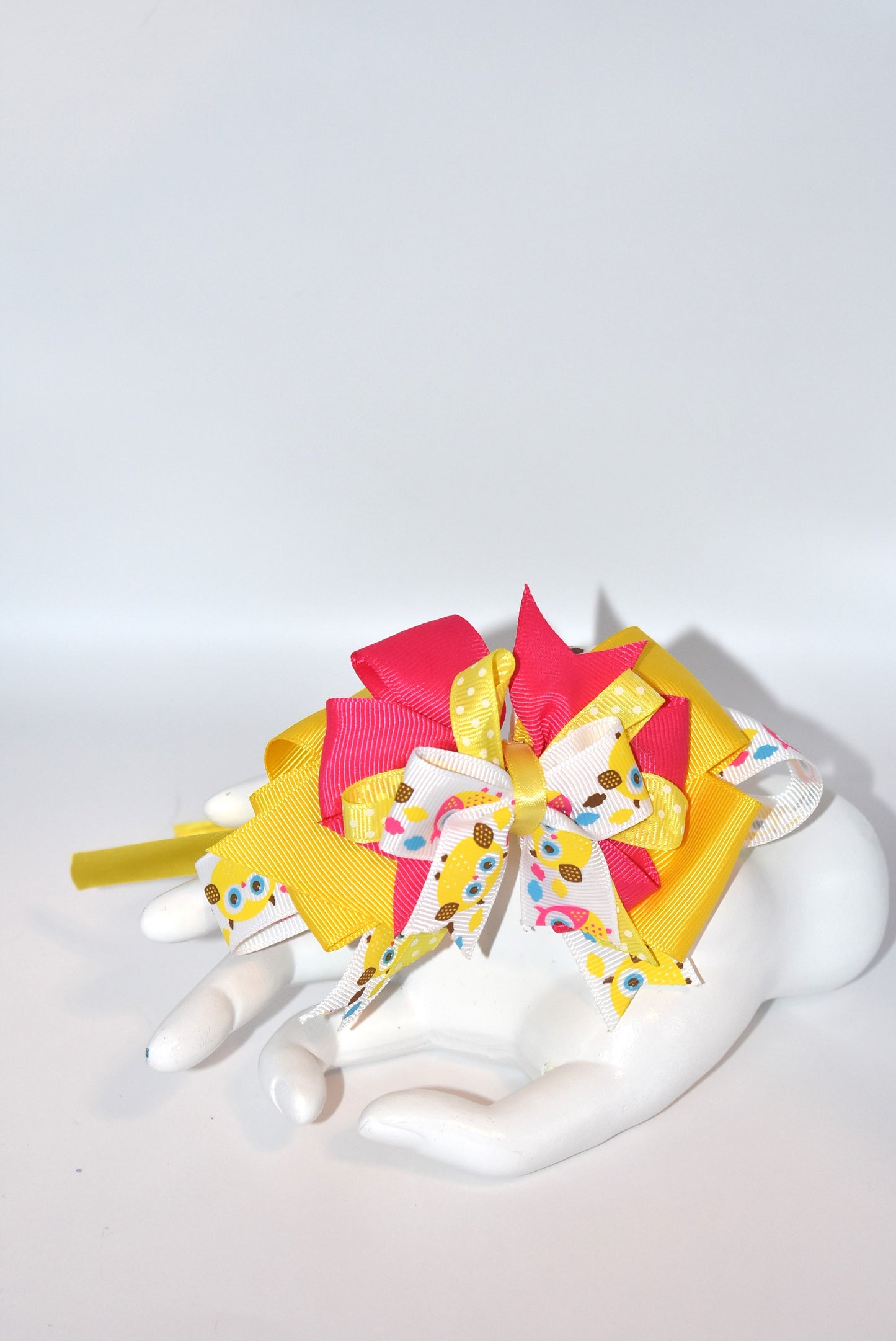 Hoot hoot! 🦉 This adorable satin-wrapped skinny headband is perfect for owl enthusiasts everywhere. Featuring a charming owl motif with pretty layers of pink and yellow ribbon, it's the ultimate accessory for adding a touch of whimsy to your look. The perfectly coordinated colors and soft satin finish make it both stylish and comfortable to wear all day long. Whether you're a devoted owl lover or just looking for something cute and quirky, this headband delivers charm in spades! 💛🩷