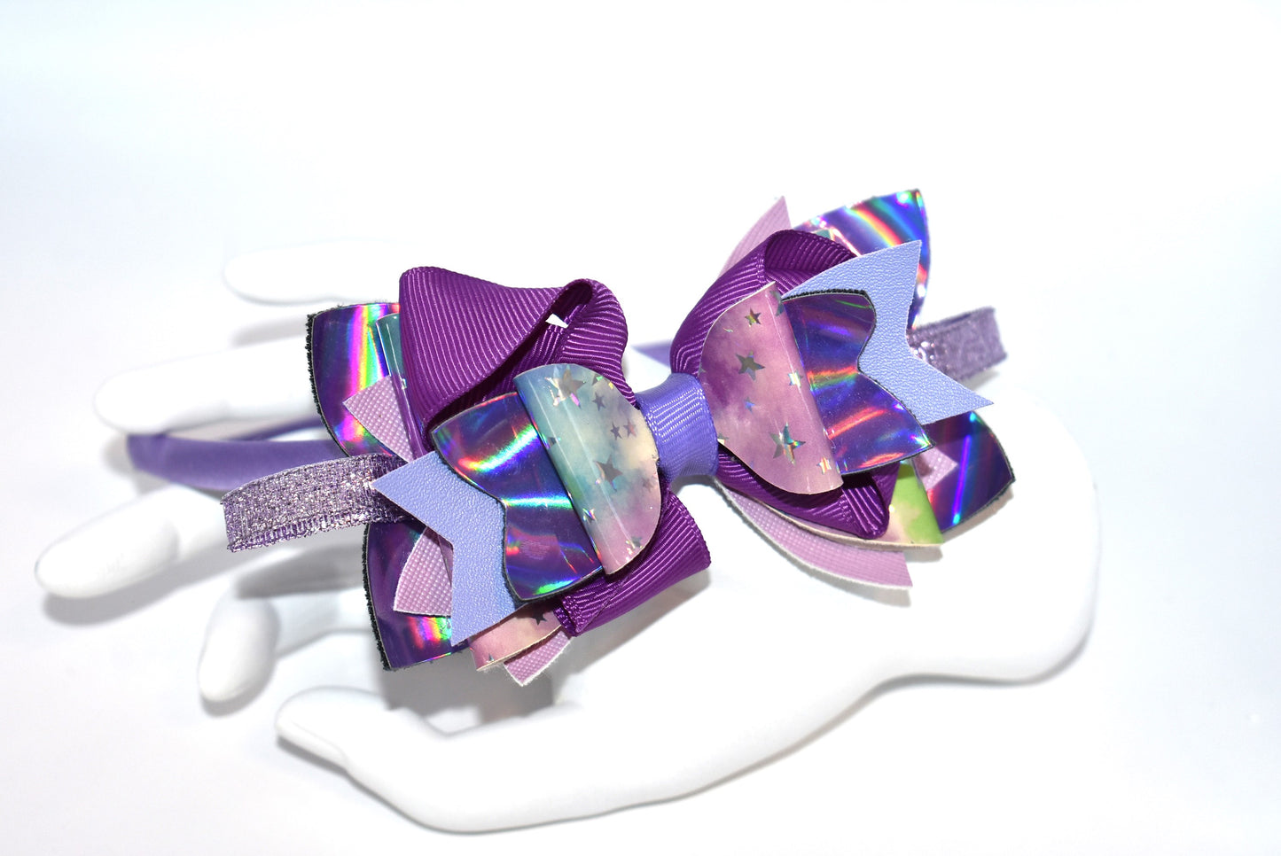 Add a pop of playful purple to your look with this bright satin headband! Thin and comfy, it’s perfect for all ages who love a splash of color. Whether you're young or young at heart, Nana’s Headband Collection 11 is your go-to for fun style and easy wear! 💜✨🎀