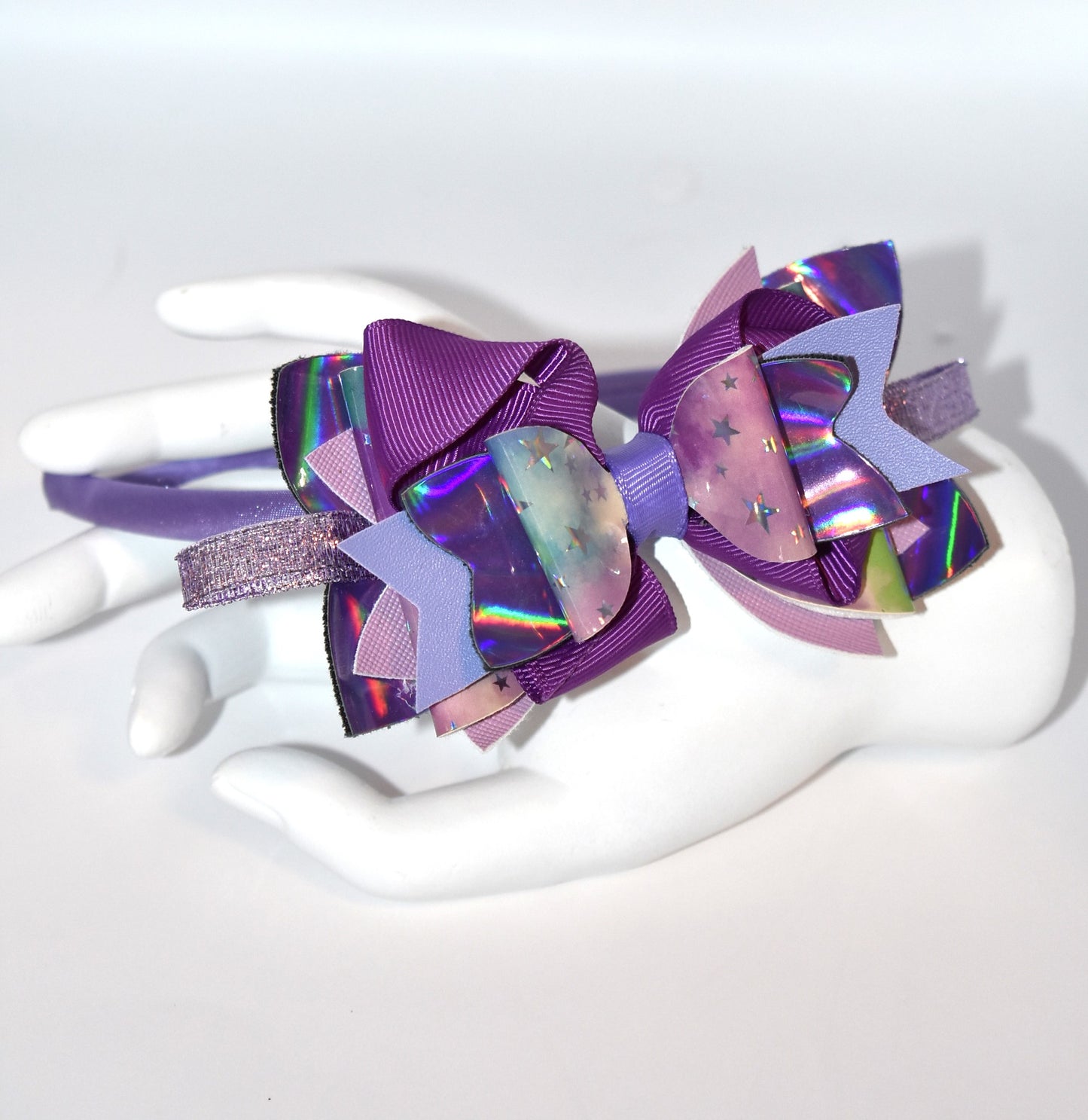 Add a pop of playful purple to your look with this bright satin headband! Thin and comfy, it’s perfect for all ages who love a splash of color. Whether you're young or young at heart, Nana’s Headband Collection 11 is your go-to for fun style and easy wear! 💜✨🎀