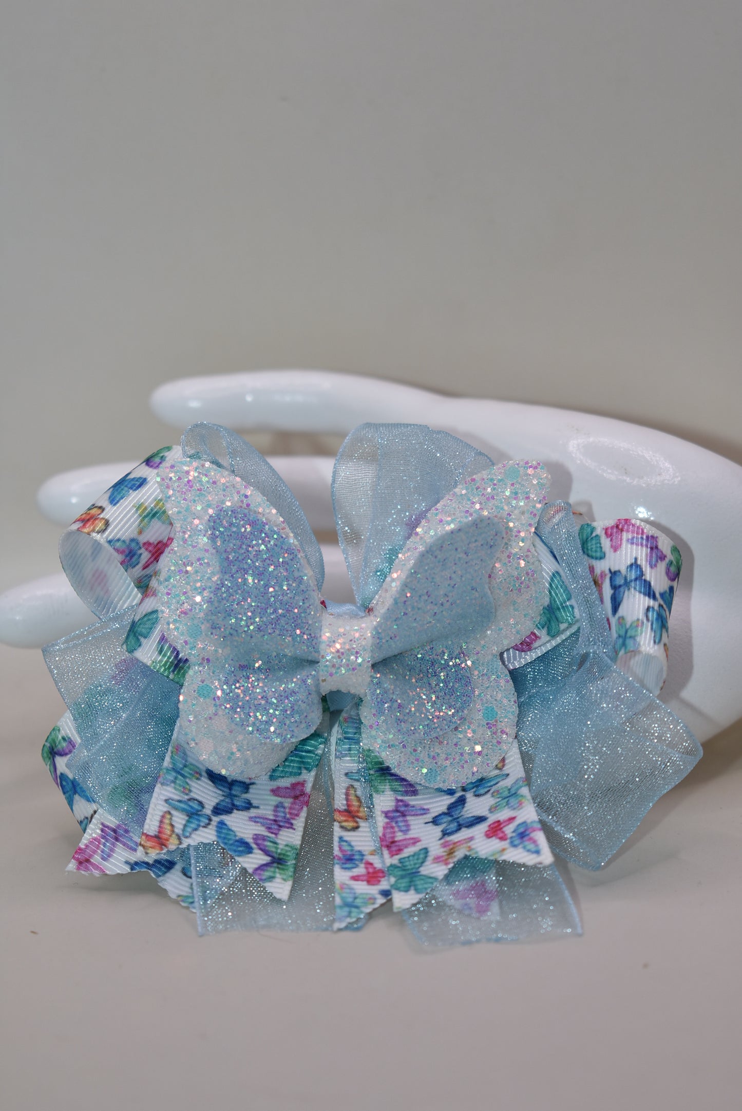 ✨ Introducing a whimsical accessory straight from Nana's Collection! This enchanting blue butterfly bow features delicate multi-colored ribbon details and luxurious layered fabric that catches the light beautifully. 🦋 The wrapped alligator clip makes it effortless to secure in your hair, keeping your style picture-perfect all day long. Perfect for adding a touch of charm and personality to any look! 💙🎀