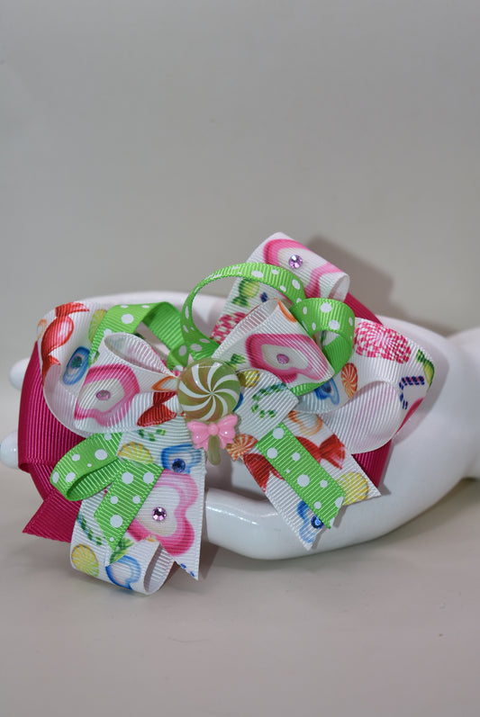 Brighten up your collection with this delightful candy bow charm! 🎀✨ Featuring layers of vibrant, eye-catching ribbon in a rainbow of colors, this playful piece brings instant joy to any accessory collection. Topped with an adorable candy charm that adds a sweet touch of whimsy, it's the perfect way to add a pop of color and fun to your style. 🍬💖 From Nana's Collection, because life's too short for boring accessories!