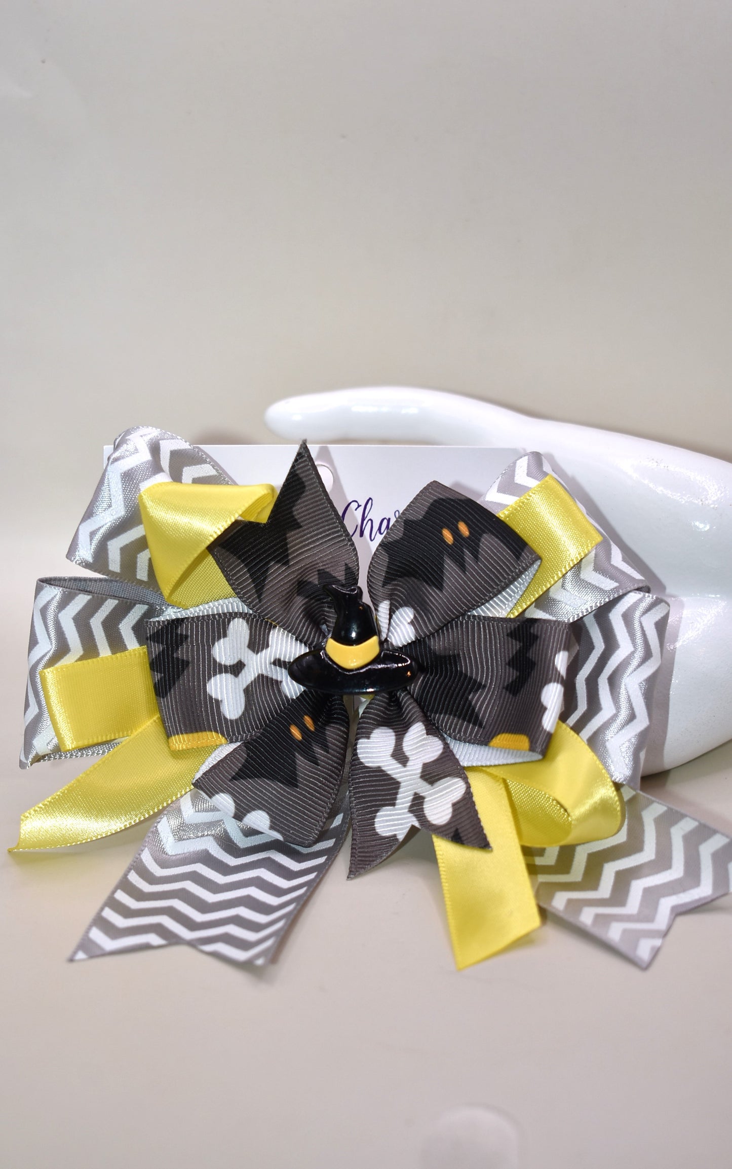 Add a pop of spooky fun with this crazy witches hat π©β¨! Perched atop a swirl of lively yellow and grey ribbons, itβs the perfect playful touch for your Halloween look ππ». The wrapped alligator clip ensures a comfy, secure fit so you can dance through the season with ease. Get ready for trick-or-treating in style! πΈοΈπ€