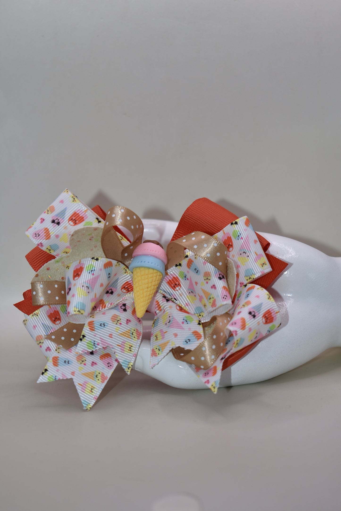 Scoop up the sweetness! 🍦 This delightful bow features layers of fun ice cream ribbon that'll make any hairstyle extra special. ✨ Topped with an adorable ice cream charm, it's the perfect playful accessory for adding a sprinkle of joy to your everyday look. 🎀 Whether you're heading to school, a party, or just want to brighten your day, this charming bow brings the fun wherever you go! 🌈
