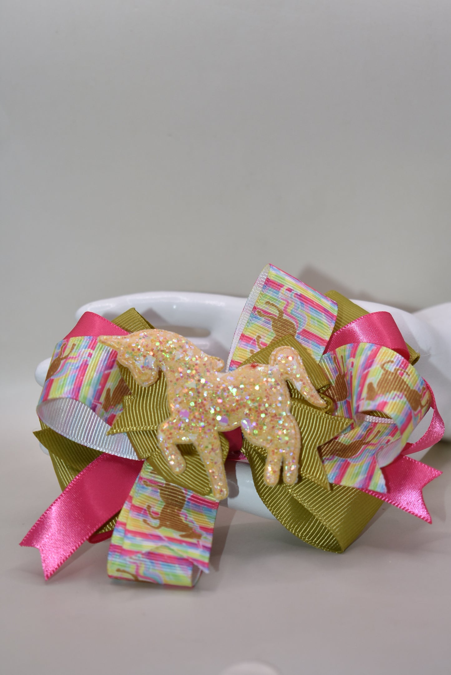 ✨ Get ready to turn heads with this absolutely magical unicorn bow! 🦄 Featuring an adorable, eye-catching gold unicorn patch perched on top of layered ribbon, this bow is pure fun and flair. The wrapped alligator clip makes it super easy to clip in and go—no fussing required! 💛 Perfect for adding a touch of whimsy and sparkle to any hairstyle. Whether you're heading to a party or just want to brighten your day, this playful accessory delivers instant charm and personality. 🎀