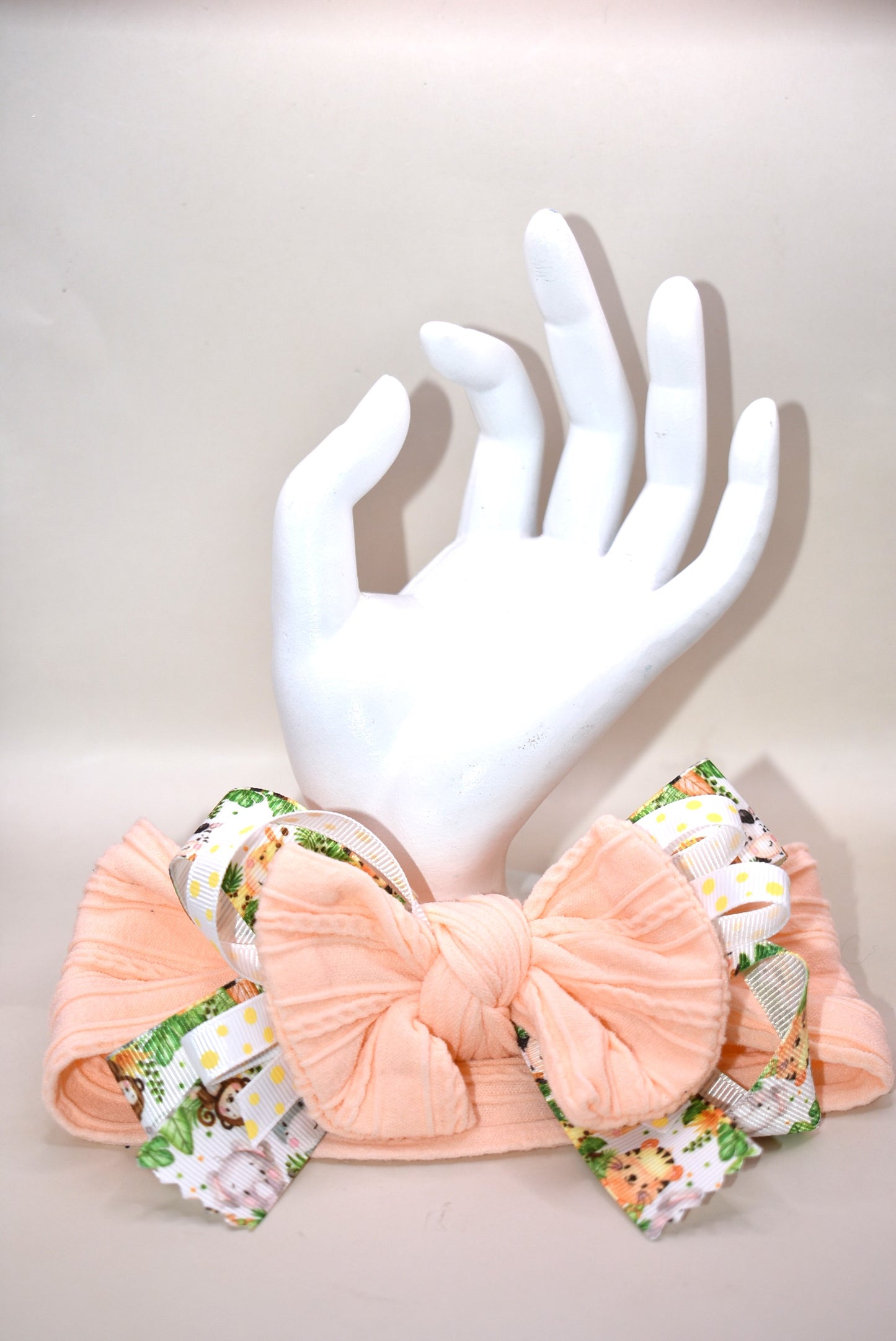 Add a splash of fun to your look with this wrapped headband featuring a super cute animal print ribbon blended with soft peach fabric. This one-of-a-kind piece is perfect for brightening your day and keeping hair stylishly in place. πΎπβ¨