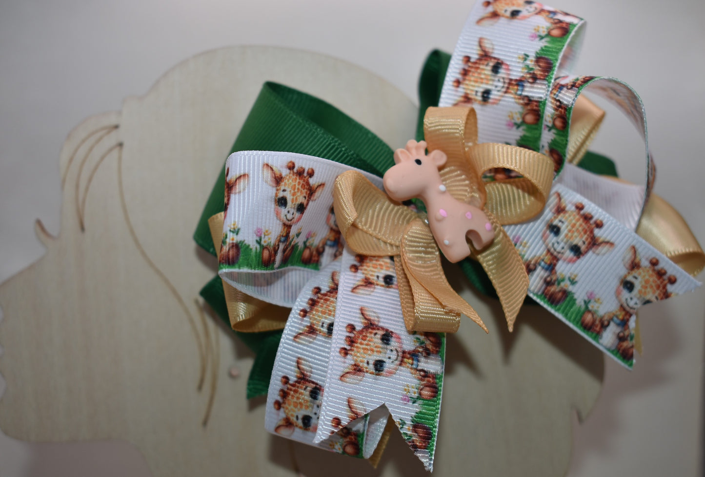 Meet your new favorite hair accessory! 🦒 This adorable giraffe bow features layered ribbons in charming giraffe print mixed with a complementary color for extra visual appeal. A precious giraffe charm sits proudly on top, adding that perfect finishing touch. The wrapped alligator clip on the back makes it super easy to secure in place, so your little one can rock this cute look all day long. Perfect for adding a splash of personality to any hairstyle! ✨🎀