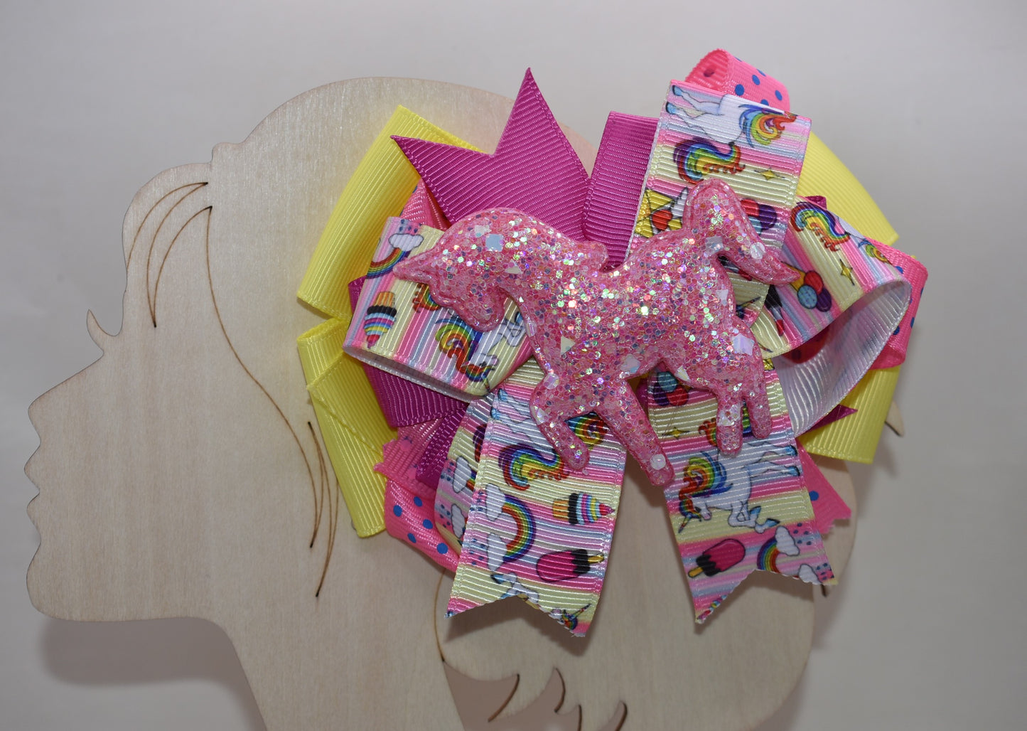 ✨ Meet your new favorite hair accessory! This one-of-a-kind bow features a gorgeous glitter unicorn figure crowned with unicorn rainbow ribbon. 🦄 Layers upon layers of vibrant, multi-colored ribbons create a whimsical masterpiece that's sure to turn heads. The secure alligator clip keeps your style in place all day long, so you can sparkle and shine from sunrise to sunset. 🎀💫 Pure magic for unicorn lovers everywhere!