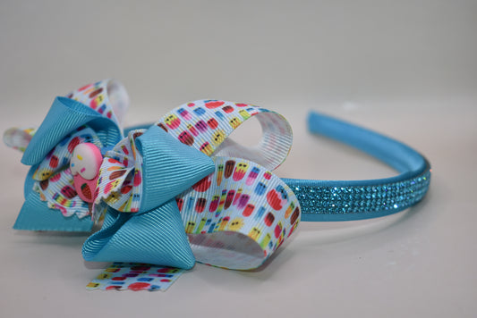 Wrap your hair in sweetness with this delightful satin headband! 🎀 Featuring a soft, flexible design that stays comfortable all day long, this charming piece showcases a playful ice cream cone charm perched on top and a bow adorned with layers of fun, glittery ribbon. 🍦✨ Perfect for ice cream lovers and fashion enthusiasts alike, it's the ideal accessory to add a whimsical touch to any outfit. Whether you're heading out for a treat or just want to spread some joy, this headband brings instant personality