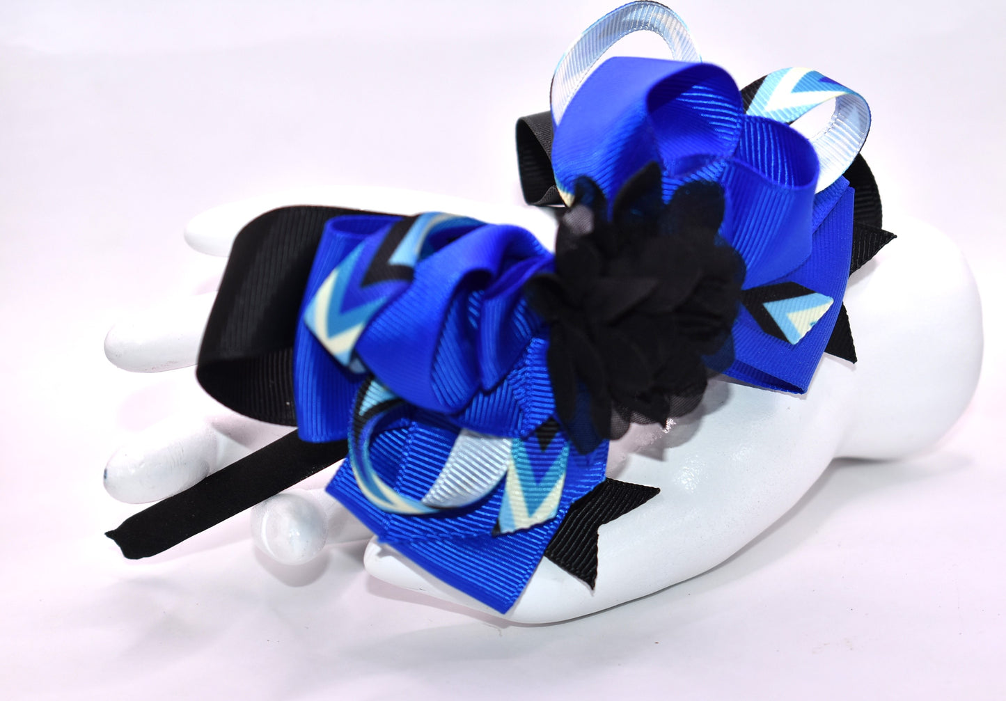 ✨ Elevate your look with this stunning blue and black headband from Nana's Collection! Crafted from silky satin for all-day comfort, this thin, lightweight design features beautifully layered ribbons that add dimension and style. Topped with an elegant black chiffon flower, it's the perfect finishing touch for any outfit—from casual days to special occasions. 🎀 Whether you're dressing up or keeping it simple, this headpiece brings that extra touch of pretty to your ensemble. 💙