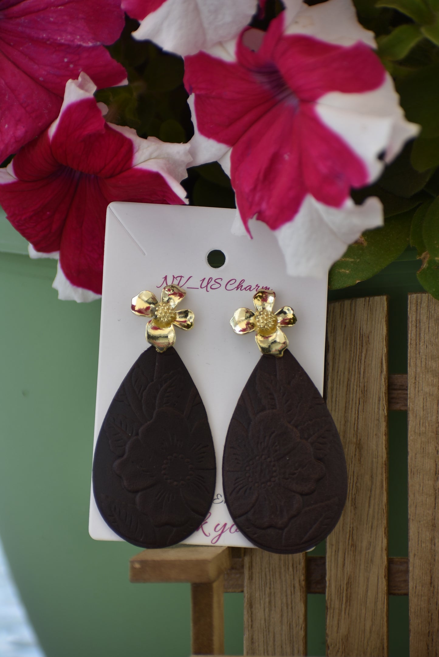 Experience the beauty of the Brown Collection. Crafted with dark brown flower-pressed faux leather in a unique teardrop shape. The elegant gold flower post earrings add a touch of glamour. Hypoallergenic and infused with Hawaiian flair, these earrings are perfect for any occasion.