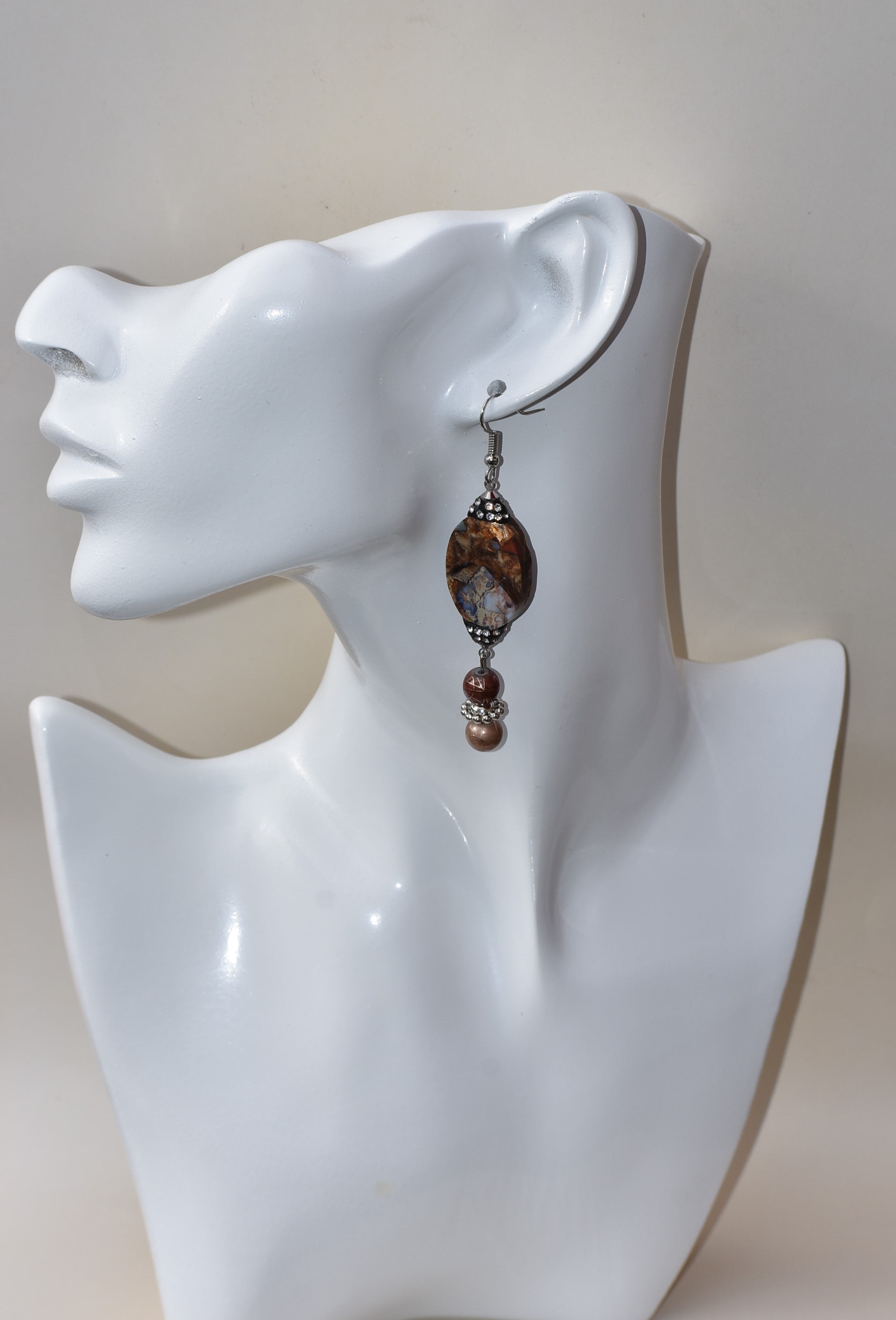 These silver hanging earrings have many different shades of brown to compliment your outfit. They hang on the long side but are comfortable for everyday wear. 