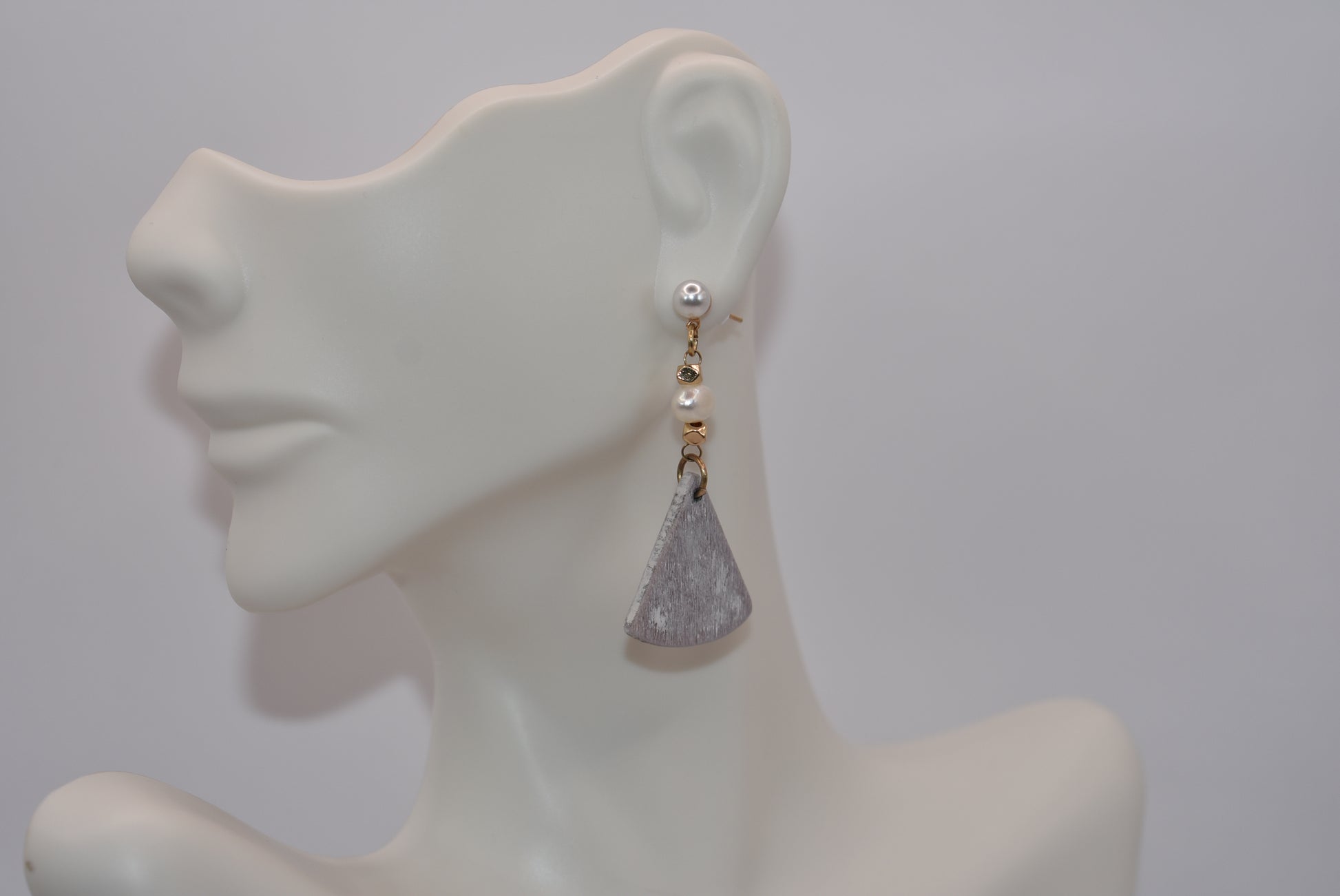 Unleash your inner uniqueness with our Gray Collection. This beautiful one-of-a-kind piece boasts a perfect combination of pretty pearls, gold filled hypoallergenic posts and a playful mix of hanging pearl, bead and wood pieces. Comfortable and easy to wear, it's sure to add a touch of personality to any outfit.