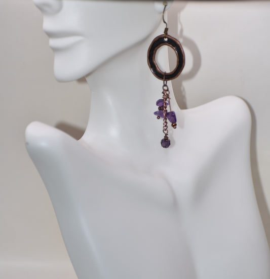 Get ready to stand out with the Purple Collection 5! These super stylish earrings feature brown copper hooks that hold a unique circle design with hanging purple beads. This unique piece will hang 3 inches on your ear and is not only comfortable to wear, but also adds a playful touch to any outfit.