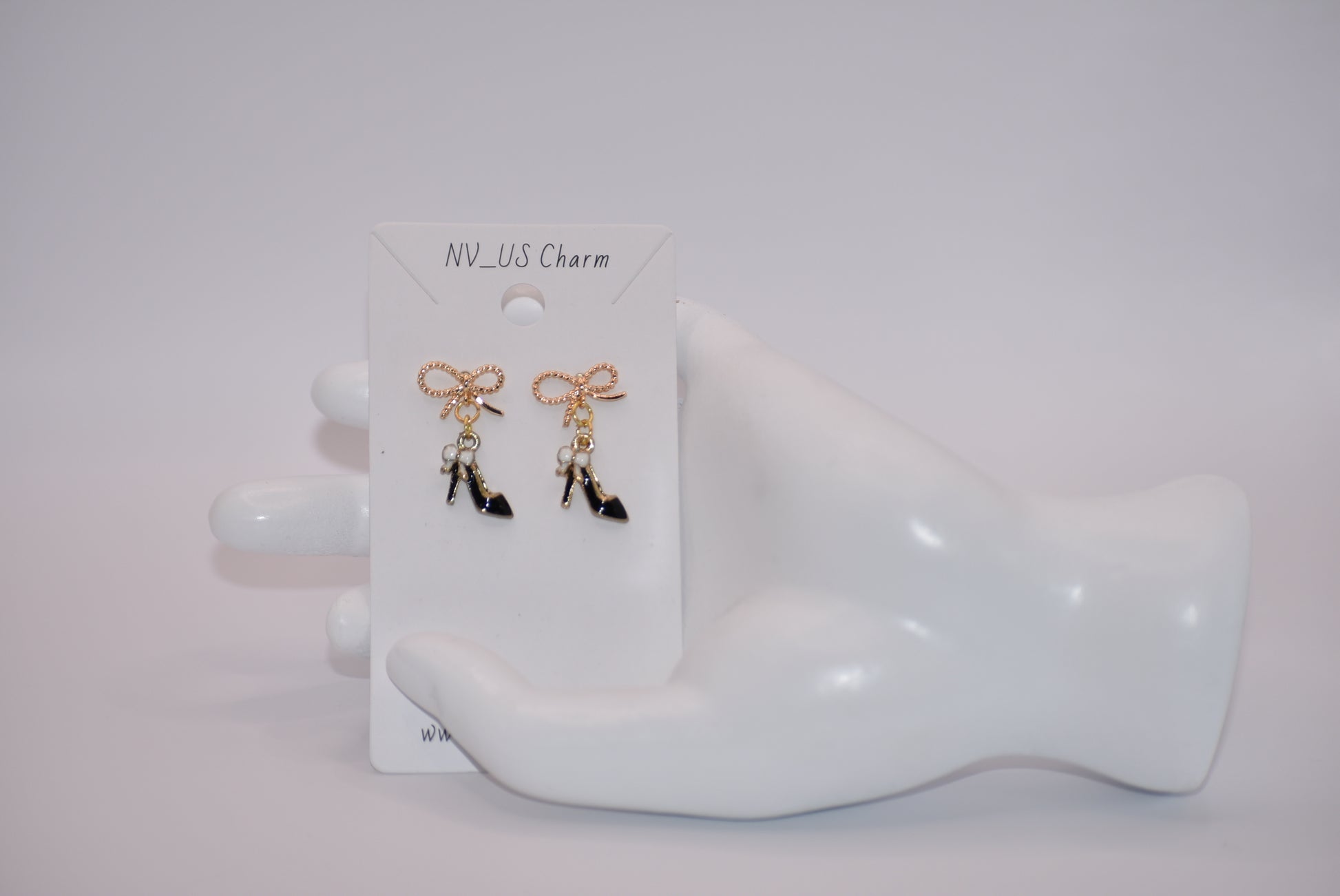 Step up your accessory game with our Black Collection! These high heel shoe earrings, featuring a gold filled hypoallergenic bow, are perfect for adding a touch of chic to your everyday look. Don't miss out on these adorable and versatile statement pieces!