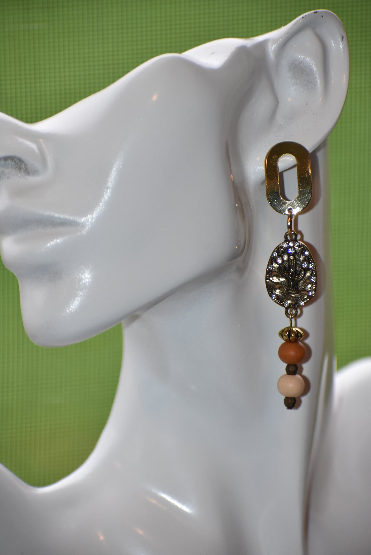 Don these wild West inspired earrings and make a fashion statement worth yodeling about! The open oblong silver posts sweetly support a cactus and crystal charm accompanied by multi-colored wood beads. Comfortable and lightweight, they hang on the long side, but will fill your ears with an unforgettable style. Whoa, Cowboy!