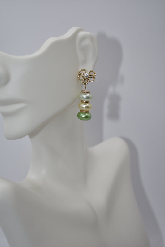 Introducing our Green Collection! Get ready to fall in love with these unique gold-filled flower post earrings. The pretty pearl center is complemented by three pearl beads in white, cream, and sage green. Don't miss out on this one-of-a-kind pair - you'll instantly fall in love!