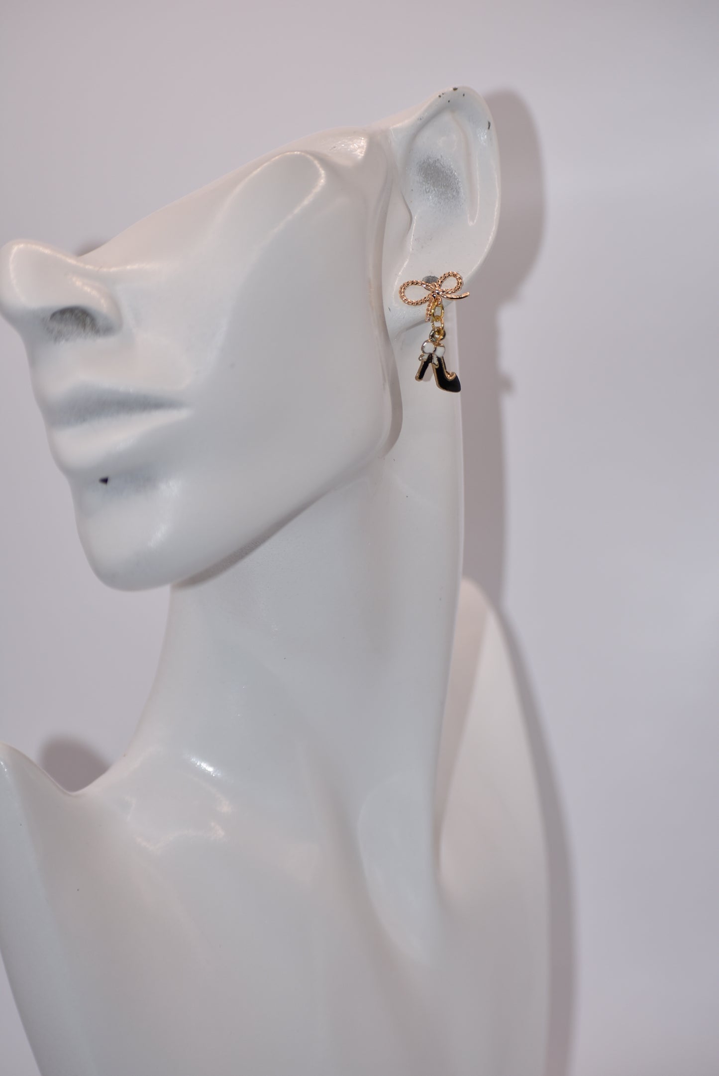 Step up your accessory game with our Black Collection! These high heel shoe earrings, featuring a gold filled hypoallergenic bow, are perfect for adding a touch of chic to your everyday look. Don't miss out on these adorable and versatile statement pieces!