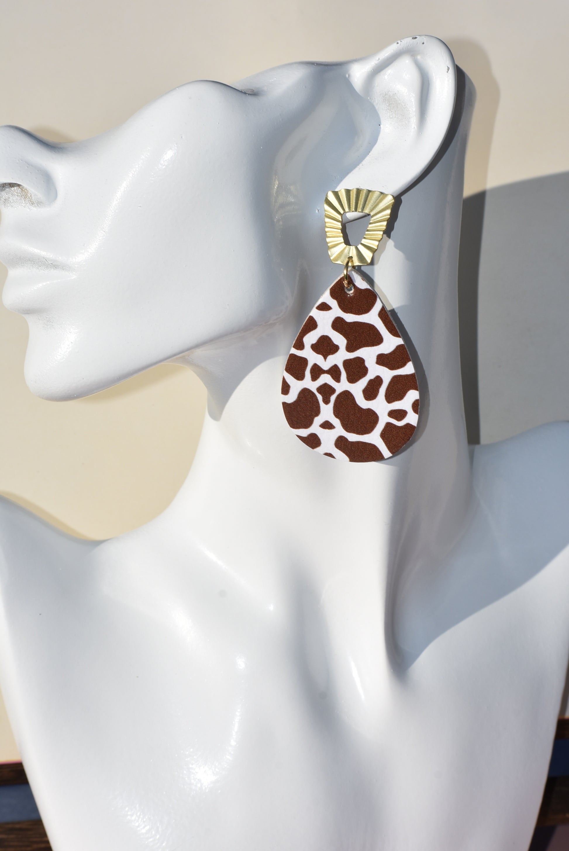 This Safari Collection earring is the perfect for adding a bit of wildness to your Fall look! The unique gold posts hold a playful brown cow print teardrop faux leather, so you can bring a bit of the barnyard into your wardrobe. Yee-haw!