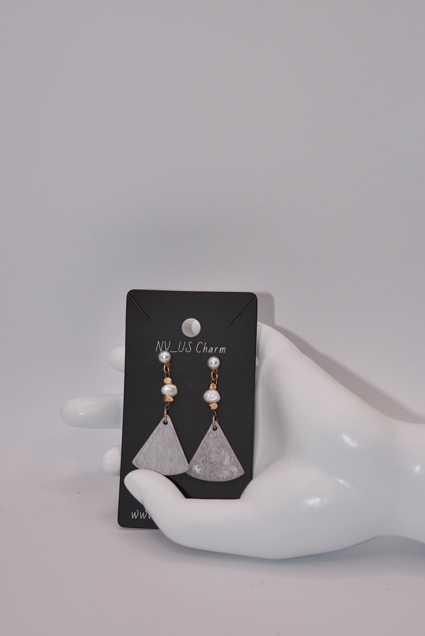 Introducing the playful Gray Collection! These beautiful stainless steel pearl posts hang comfortably on your ear, adding a stylish and lightweight touch to any outfit. Less than 2 inches, these earrings are super comfortable for all day wear.