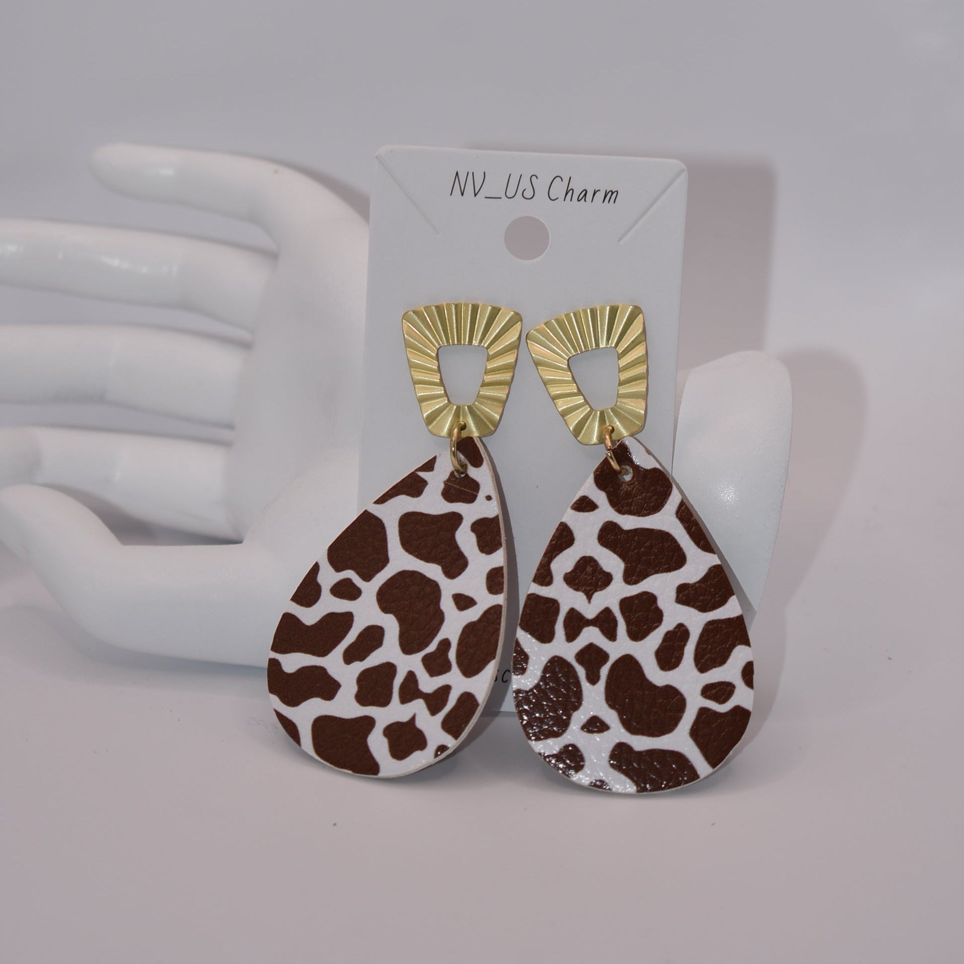 This Safari Collection earring is the perfect for adding a bit of wildness to your Fall look! The unique gold posts hold a playful brown cow print teardrop faux leather, so you can bring a bit of the barnyard into your wardrobe. Yee-haw!