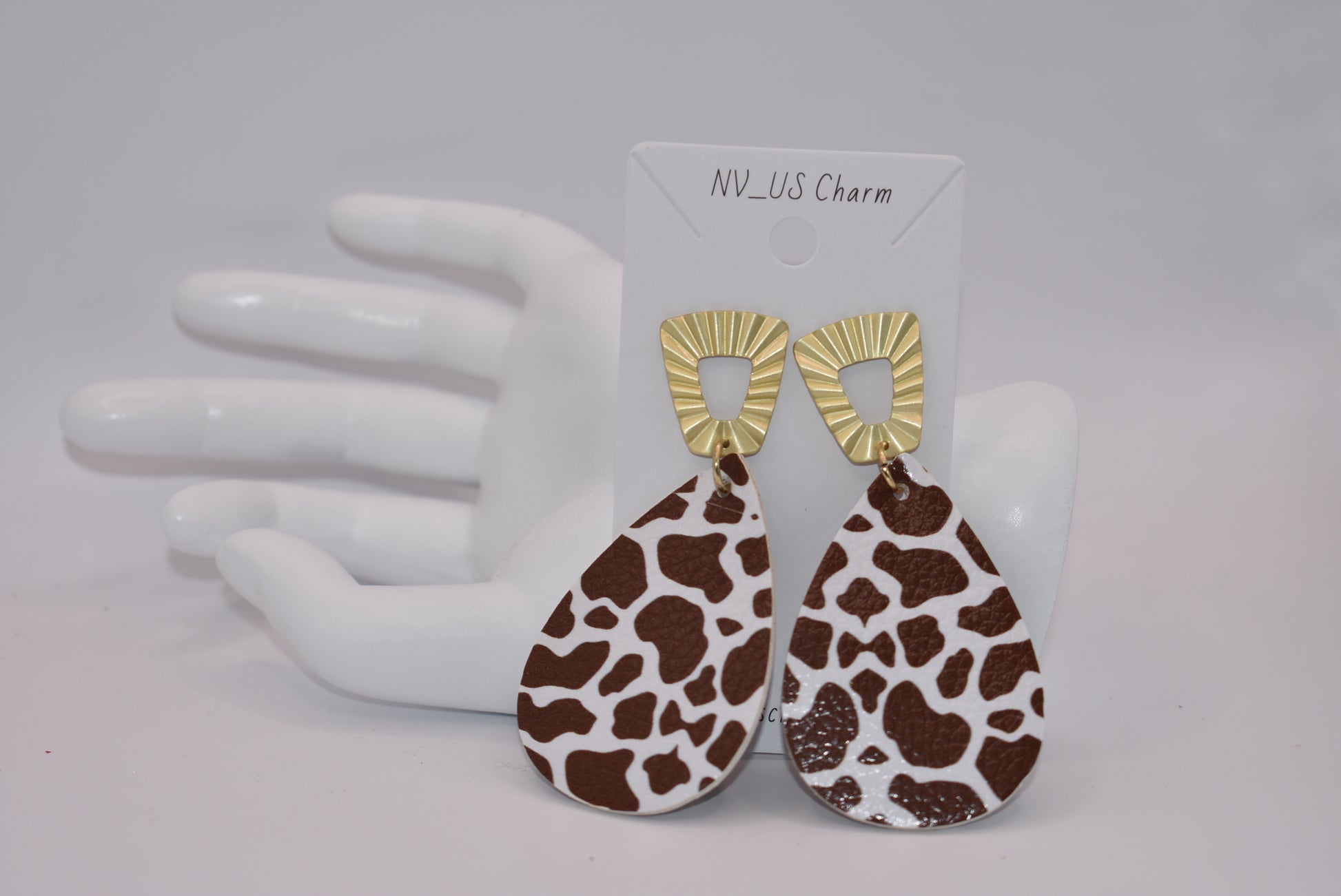 This Safari Collection earring is the perfect for adding a bit of wildness to your Fall look! The unique gold posts hold a playful brown cow print teardrop faux leather, so you can bring a bit of the barnyard into your wardrobe. Yee-haw!