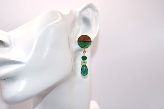 Introducing our Green Collection! These unique earrings feature wood and resin posts, adorned with a mix of emerald green and light green crystals. Whether dressing up or down, these earrings are sure to make a statement and capture your heart.