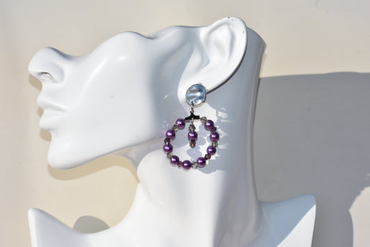 Introducing the Purple Collection - the trendsetting earrings with a pop of color! Silver round hypoallergenic posts hold the beautiful purple pearl and light gray crystal combo for a look that's sure to make heads turn and you shine!