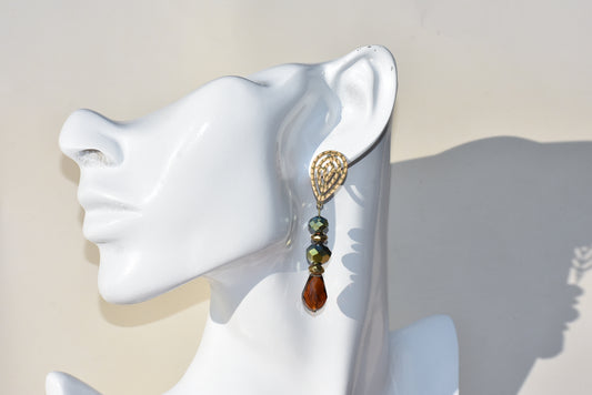 Green and Amber shimmering beads with gold accents make these earrings modern and perfect for your outfit. Beautiful filigree gold posts look so pretty on the ear.&nbsp; Hypoallergenic and perfect for sensitive ears.&nbsp; this is a one-of-a-kind-piece.&nbsp;&nbsp;